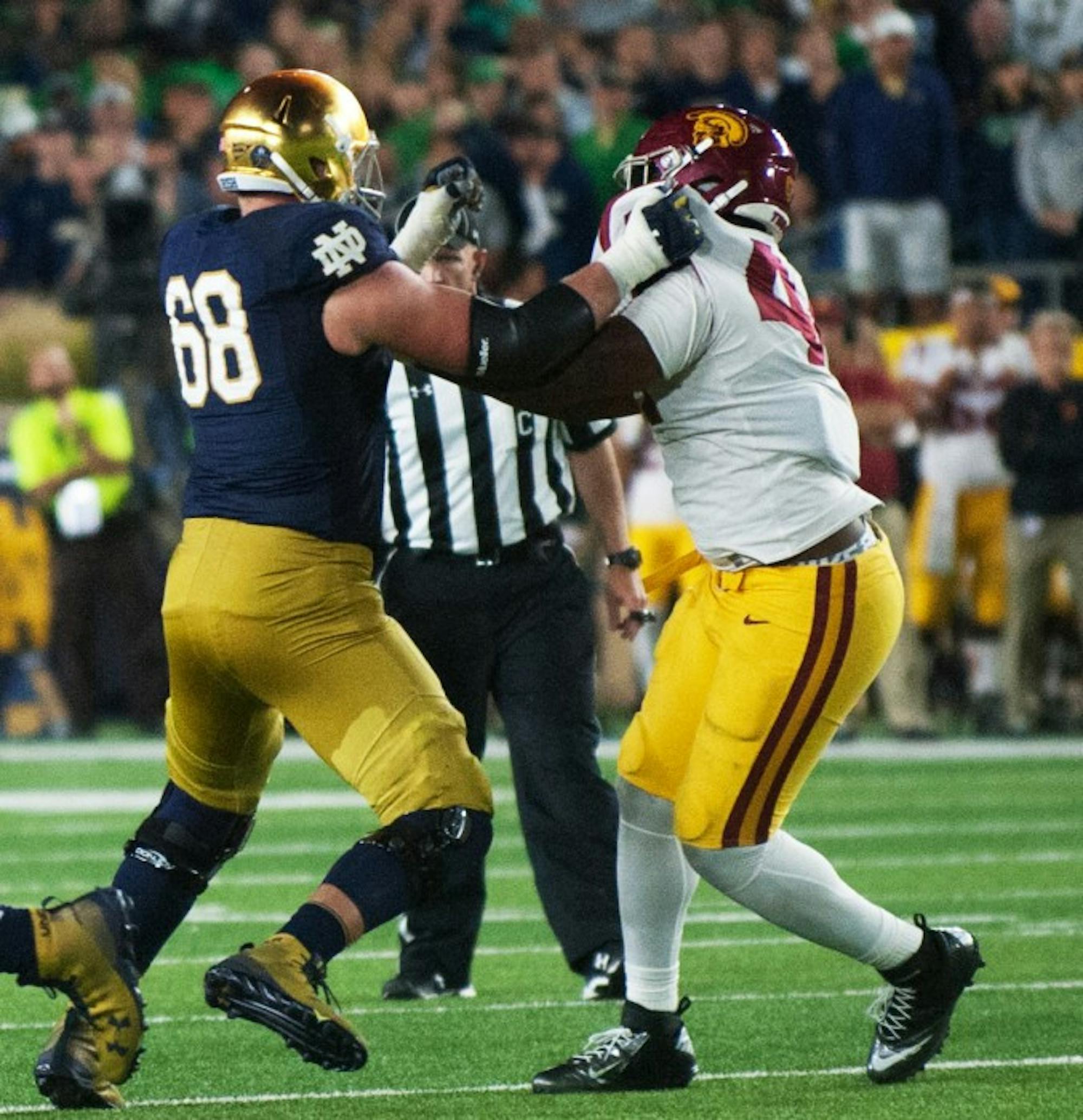 Graduate student left tacke Mike McGlinchey battles to protect the quarterback during Notre Dame's 49-14 win over USC on Sat.