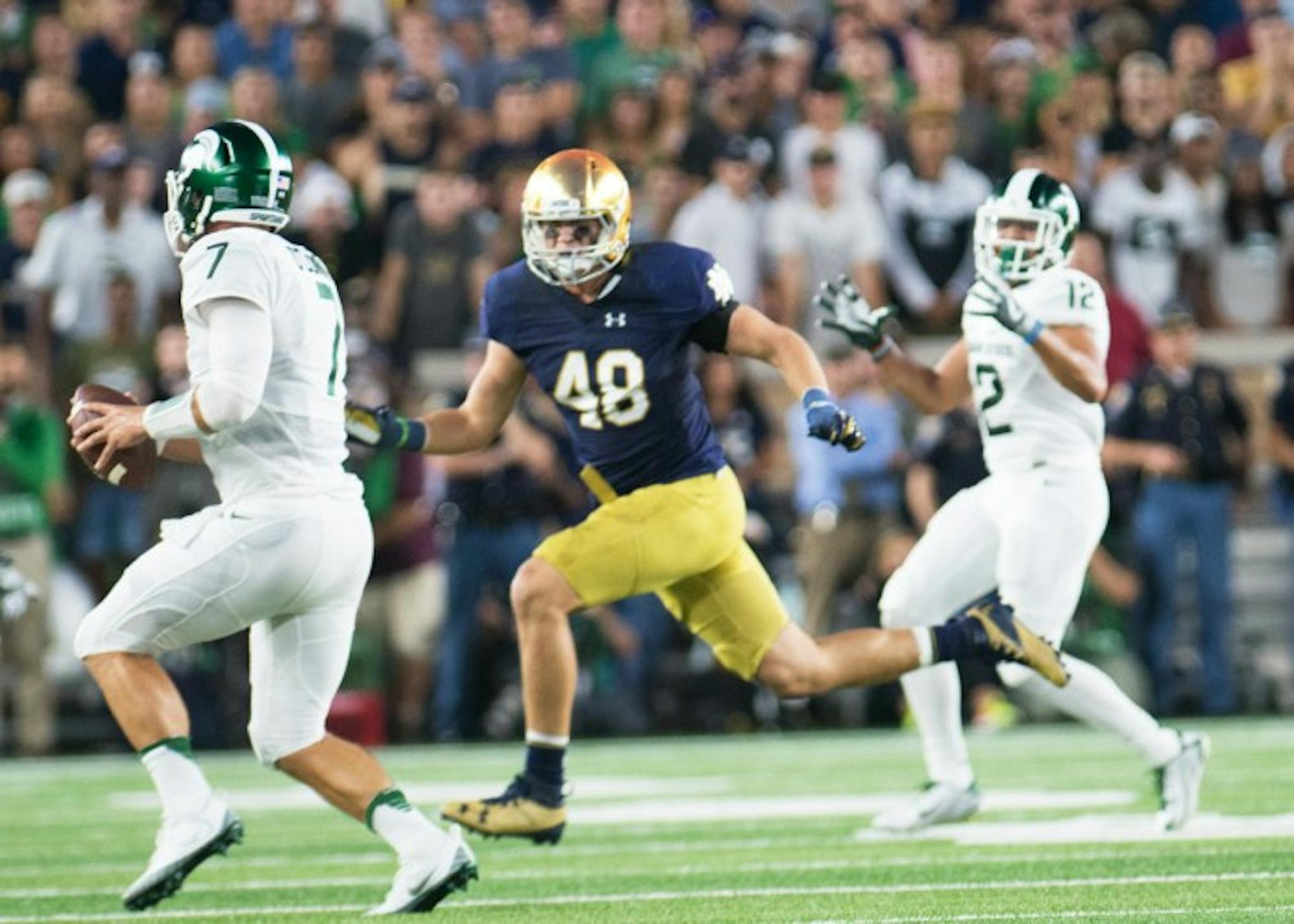 Irish junior linebacker Greer Martini chases the quarterback during Notre Dame’s 36-28 loss on Saturday. Martini has 16 total tackles on the season and has shared time with sophomore Te’von Coney.