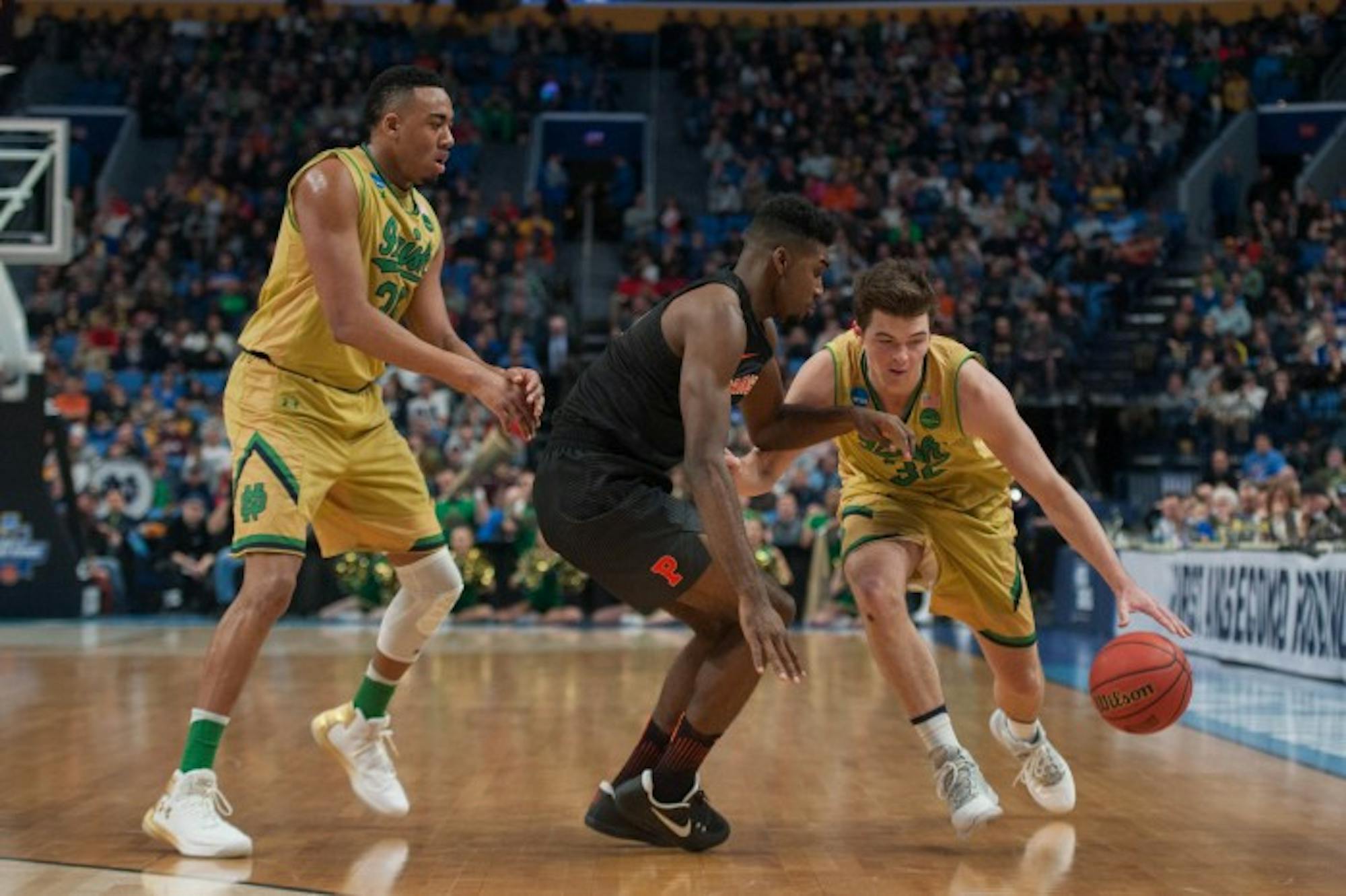 Irish senior guard Steve Vasturia tries to fend off a Princeton defender.