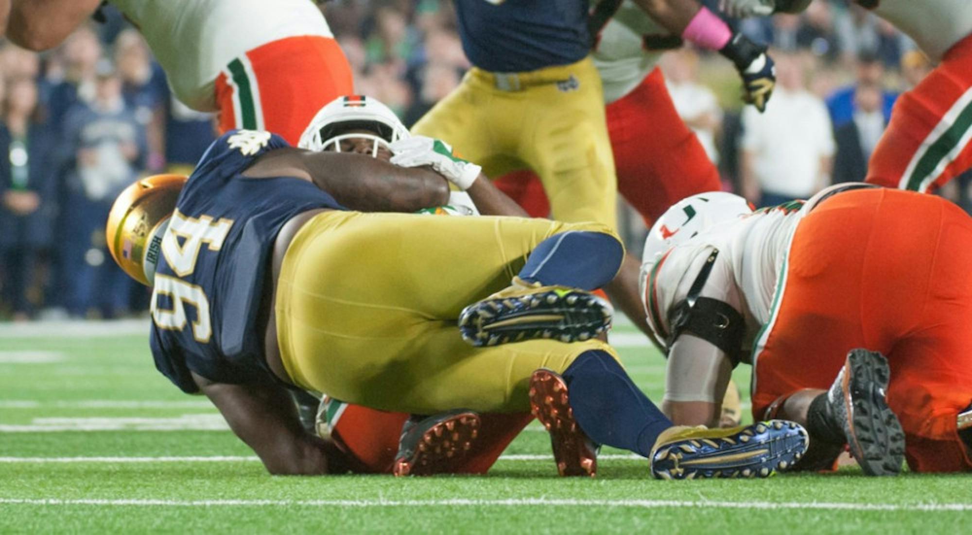 Irish graduate student defensive lineman Jarron Jones swallows Miami sophomore running back Mark Walton in the backfield during Notre Dame’s 30-27 victory over the Hurricanes at Notre Dame Stadium. Jones finished with seven total tackles — six of them for a loss, including one sack — and one pass break up in the win.