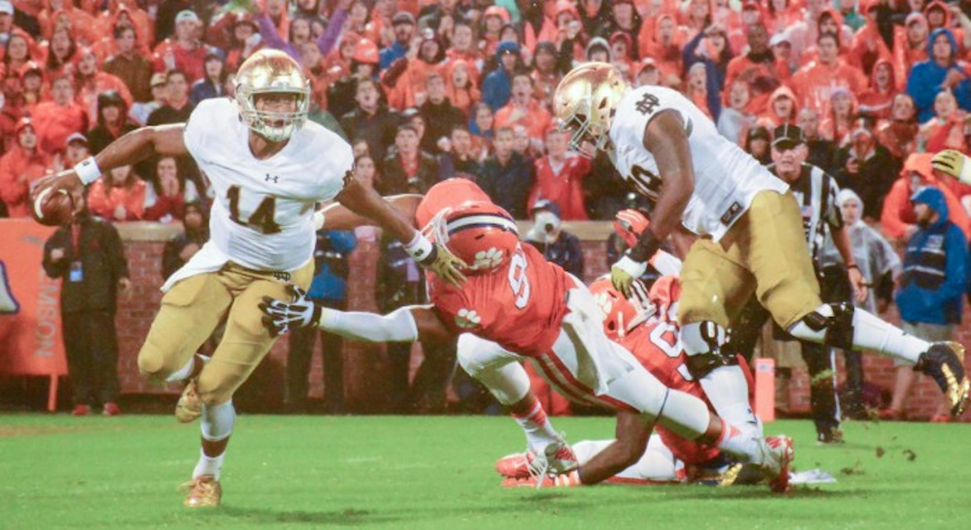 Sophomore quarterback DeShone Kizer breaks a tackle during Notre Dame’s loss to No. 6 Clemson on Saturday at Memorial Stadium. The Irish coaching staff has praised his poise and leadership despite the loss. Notre Dame will look to rebound this Saturday when it welcomes Navy to campus.