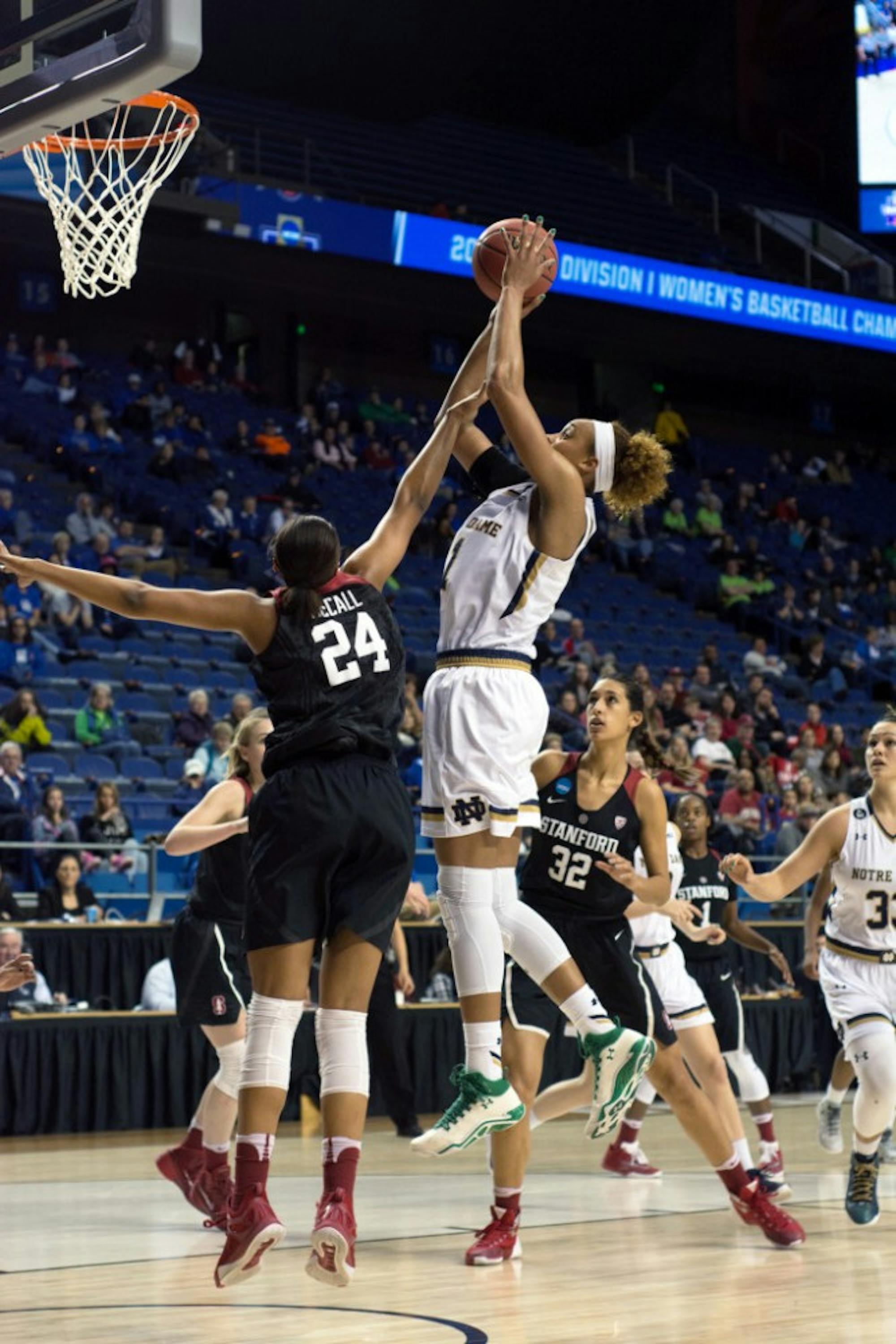 Irish sophomore forward Brianna Turner jumps over a defender for a layup during Notre Dame’s 90-84 loss to Stanford on March 25.