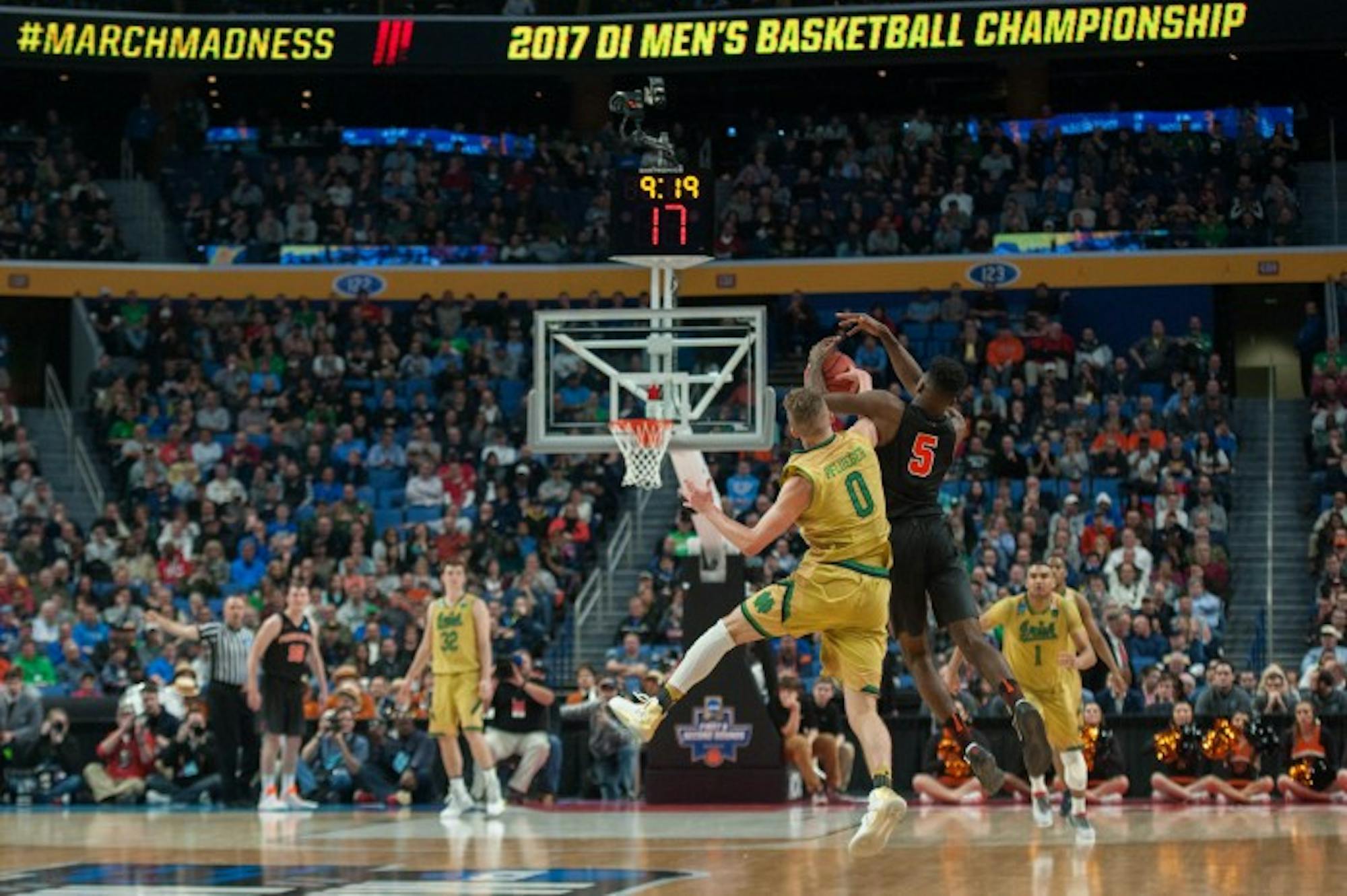 Irish sophomore guard Rex Pflueger competes for a loose ball with a Princeton player in Notre Dame's 60-58 win over the Tigers on Thursday at KeyBank Arena.