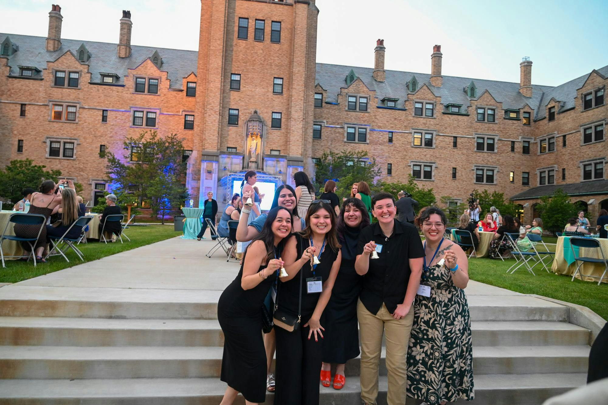Alumnae pose with bells given during the afterparty