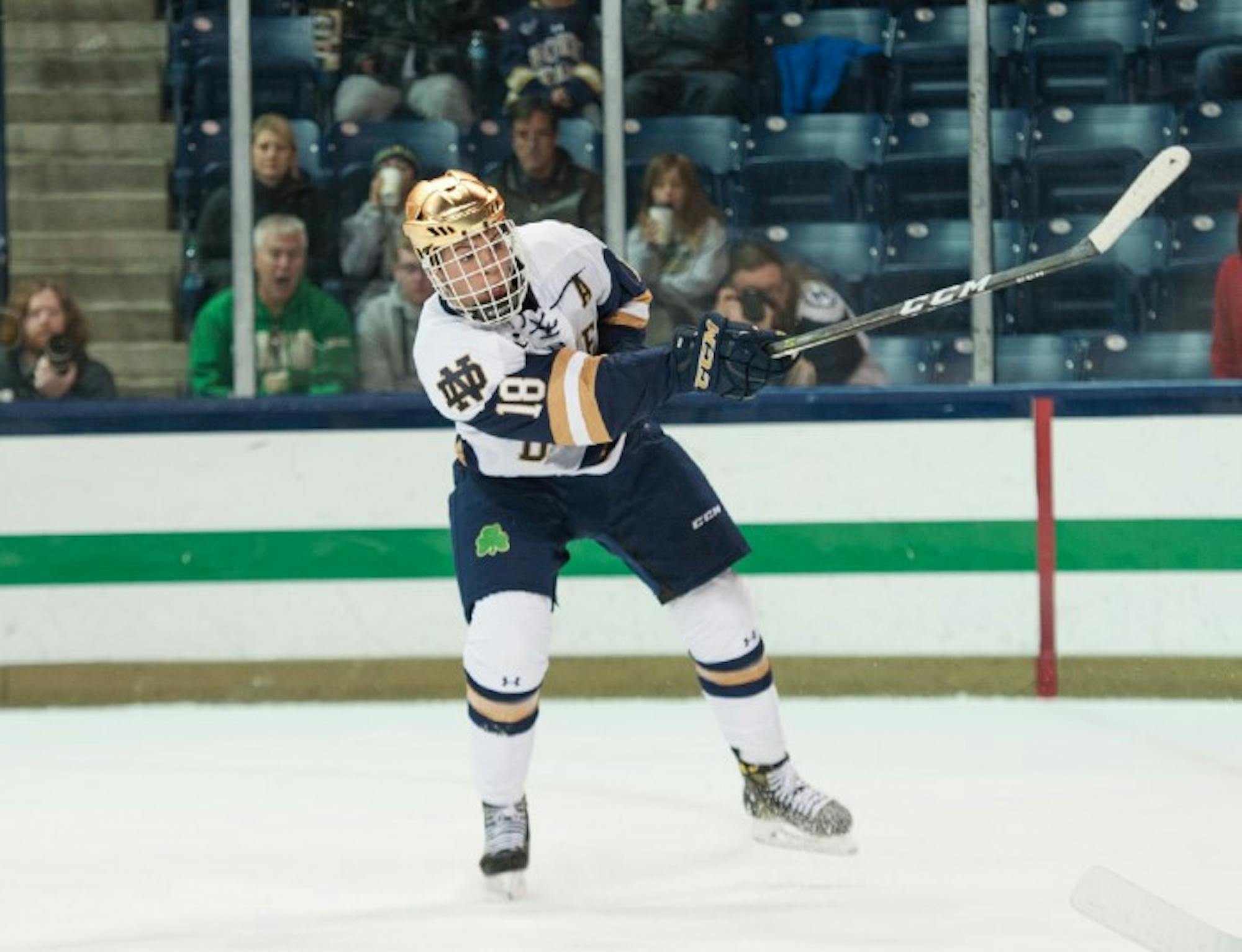 Irish junior forward Jake Evans sends the puck flying in Notre Dame’s 4-2 loss to UConn on Oct. 27 at Compton Family Ice Arena.