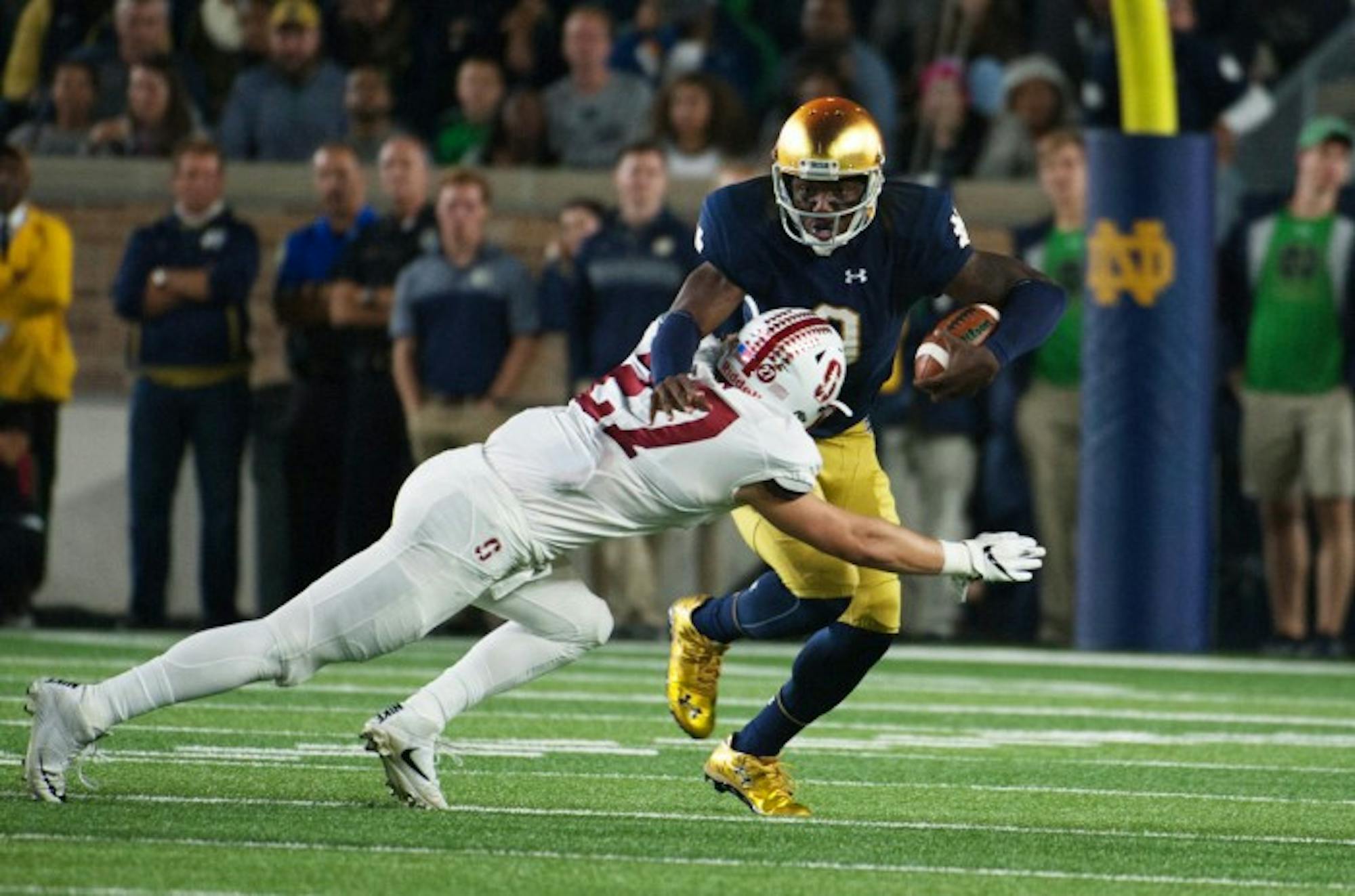 Senior Irish quarterback Malik Zaire is tackled by a Stanford defender in Notre Dame's 17-10 loss to the Cardinal on Saturday.