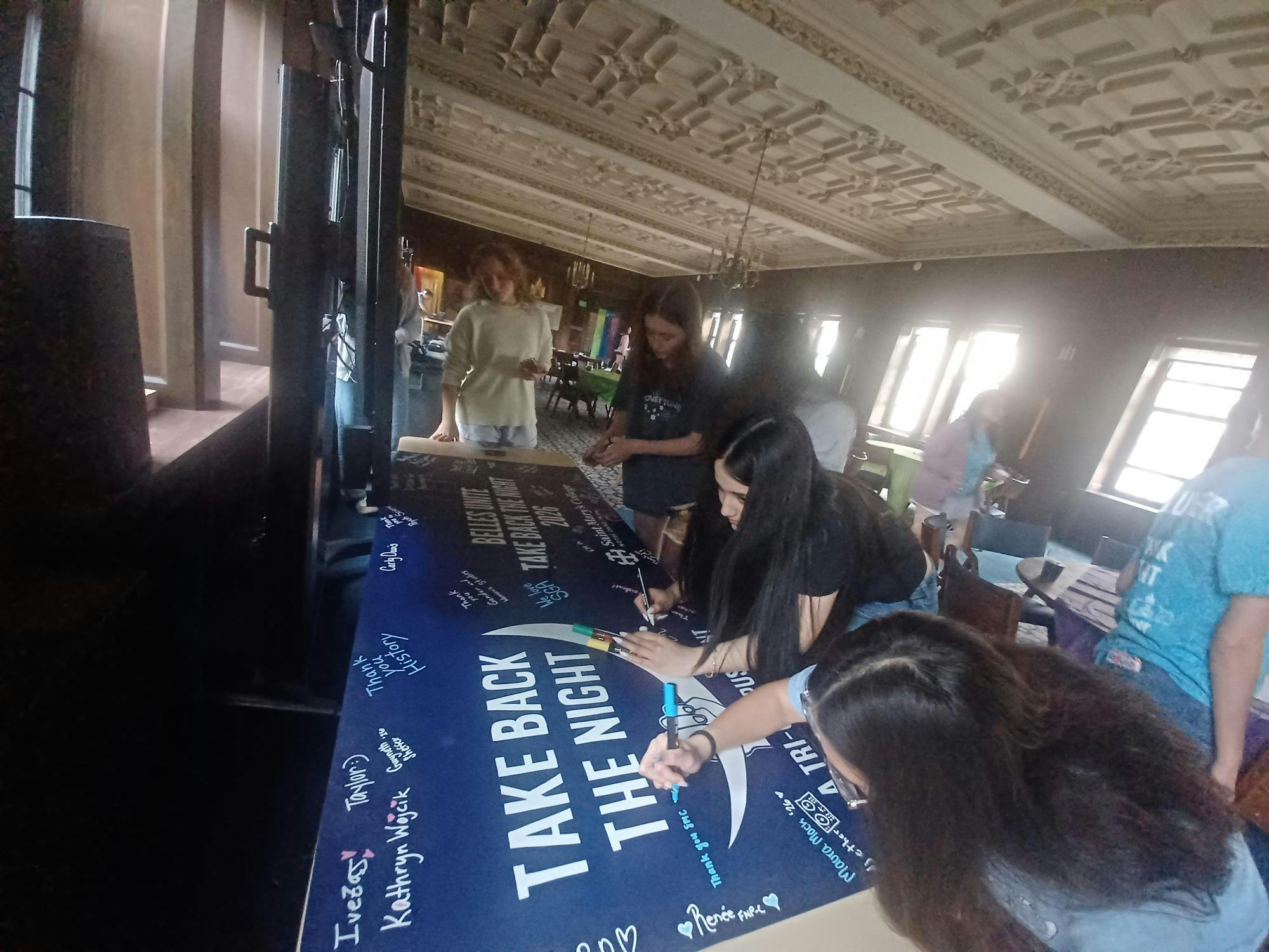 Student sign Take Back the Night poster ahead of march.jpg