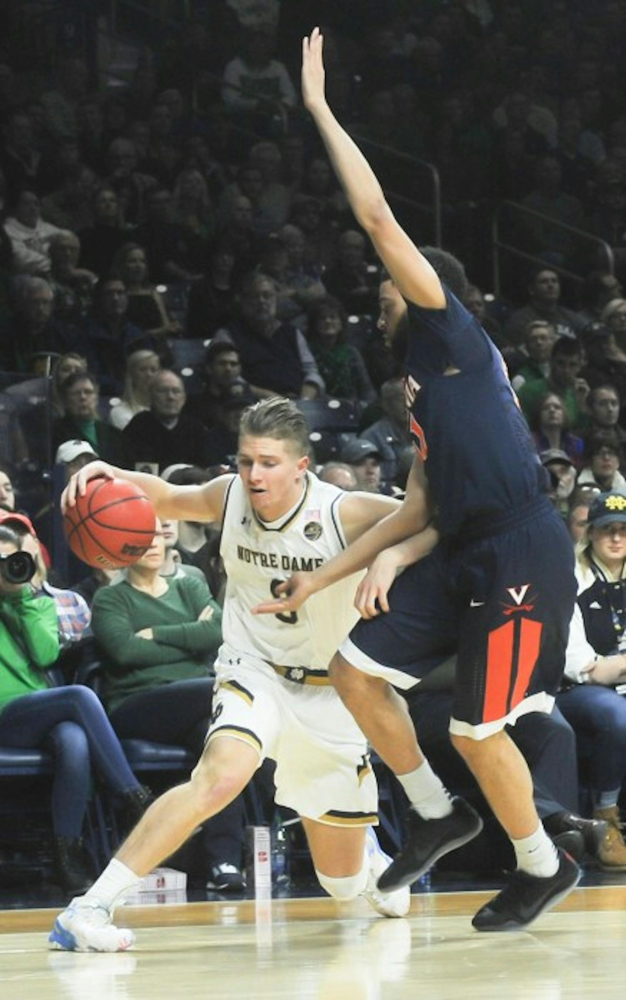 Irish sophomore guard looks to get by the Cavalier defender during Notre Dame’s 71-54 loss to Virginia on Tuesday at Purcell Pavilion.