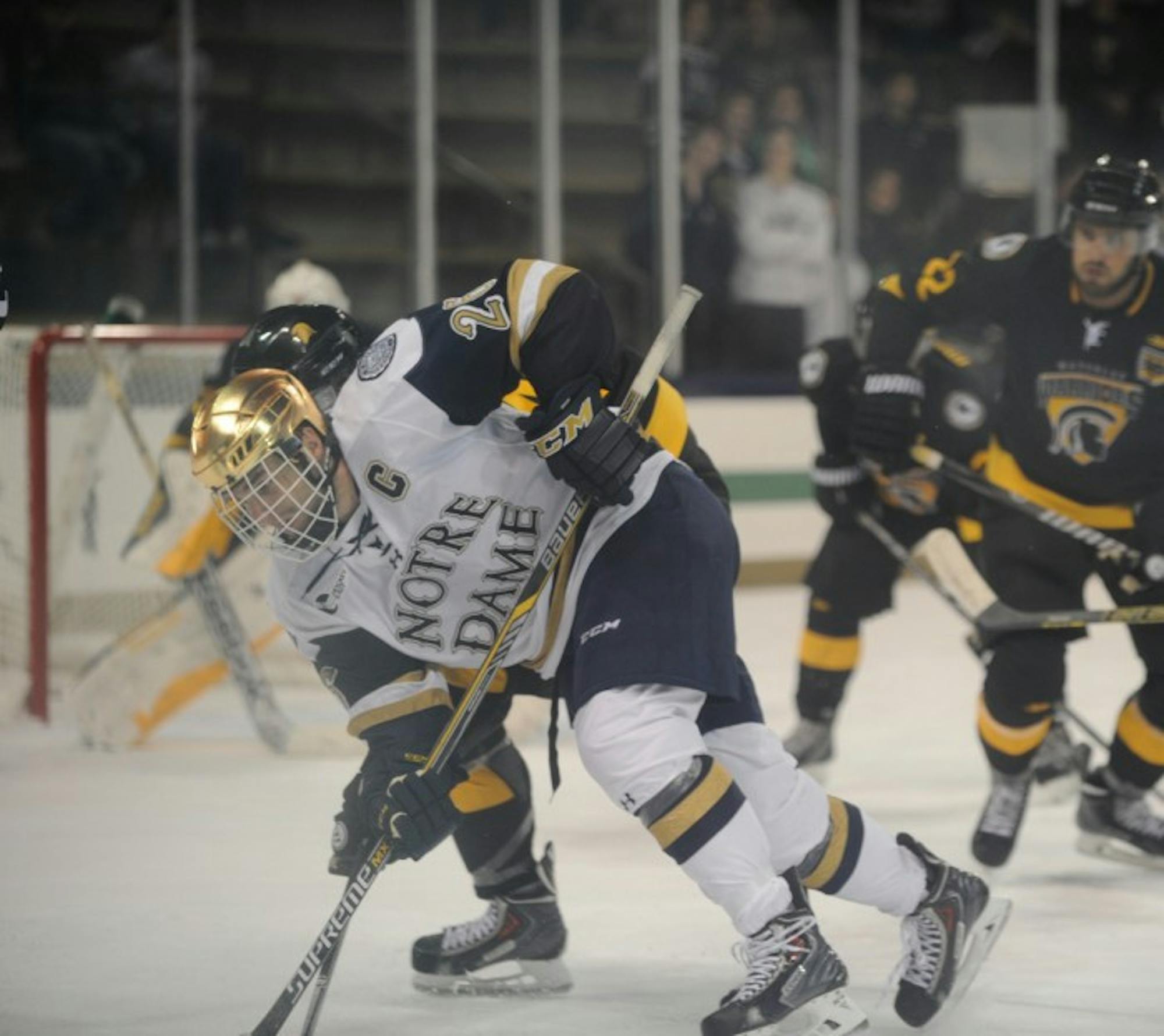 Irish junior center and captain Steven Fogarty fights for the puck in Notre Dame’s 5-4 exhibition loss to Waterloo on Sunday at Compton Family Ice Arena. Fogarty won seven of 10 faceoffs in the game.