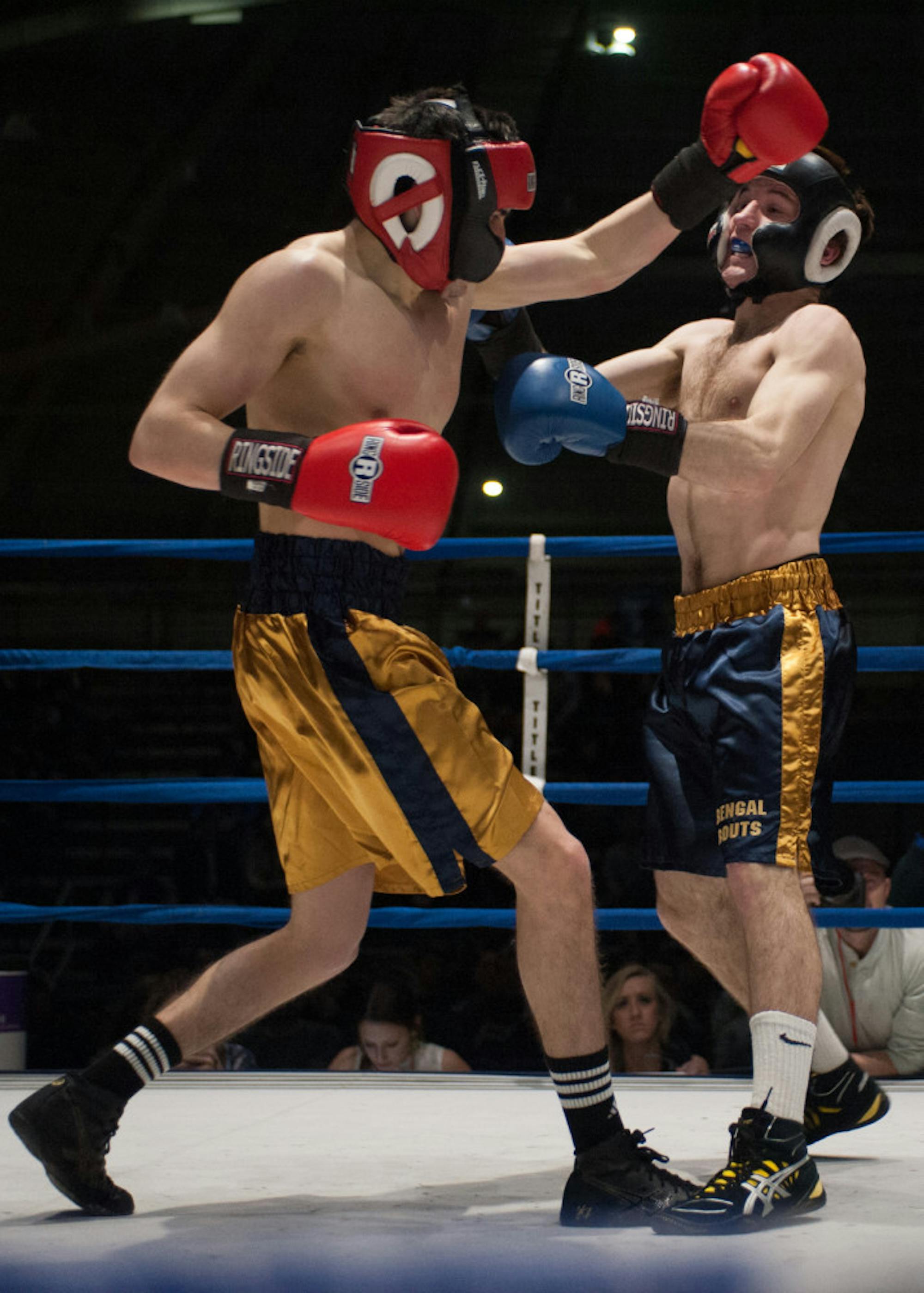 Senior Chris Tricario, right, fights during the 2014 Bengal Bouts at Joyce Fieldhouse. Tricario was unable to participate in this year’s competition due to an injury but remained involved in Bengal Bouts.