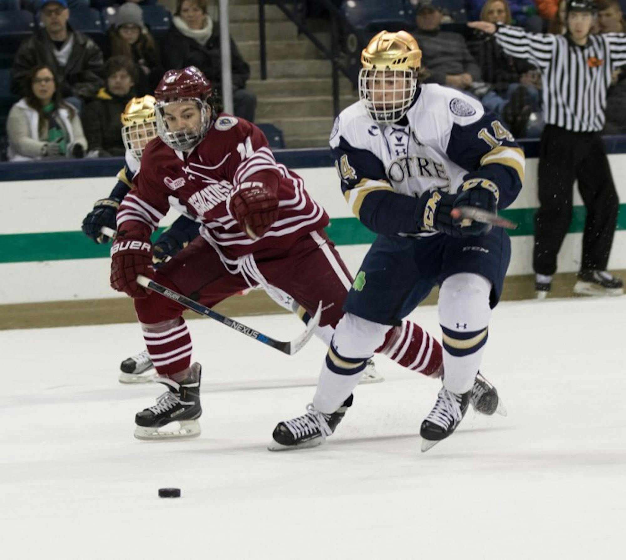 Irish senior center Thomas DiPauli races a UMass defender to the puck during Notre Dame’s 5-1 home  victory on Sunday. The Irish will take on Boston College on Thursday in Chestnut Hill, Massachusetts.