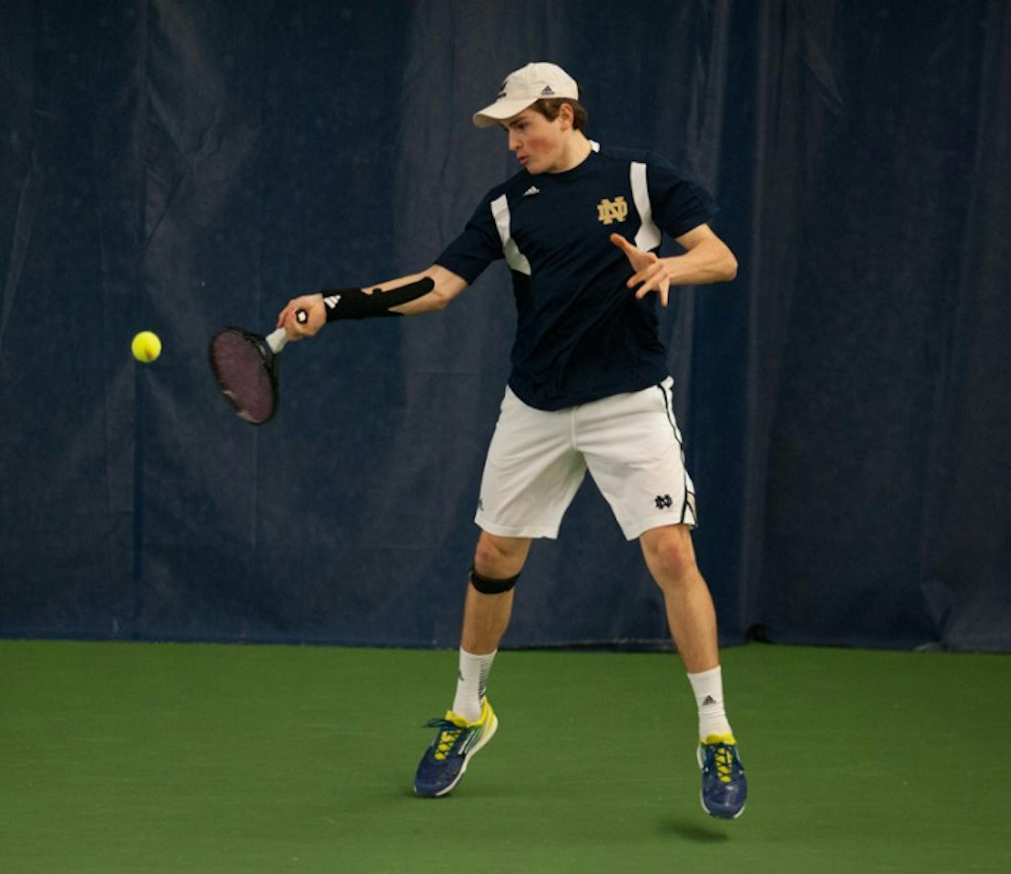 Irish sophomore Eric Schnurrenburger returns the ball during Notre Dame's victory over Kentucky on Feb. 2. Through Schnurrenburger lost both his matches, the Irish still managed to beat the WIldcats 4-3.