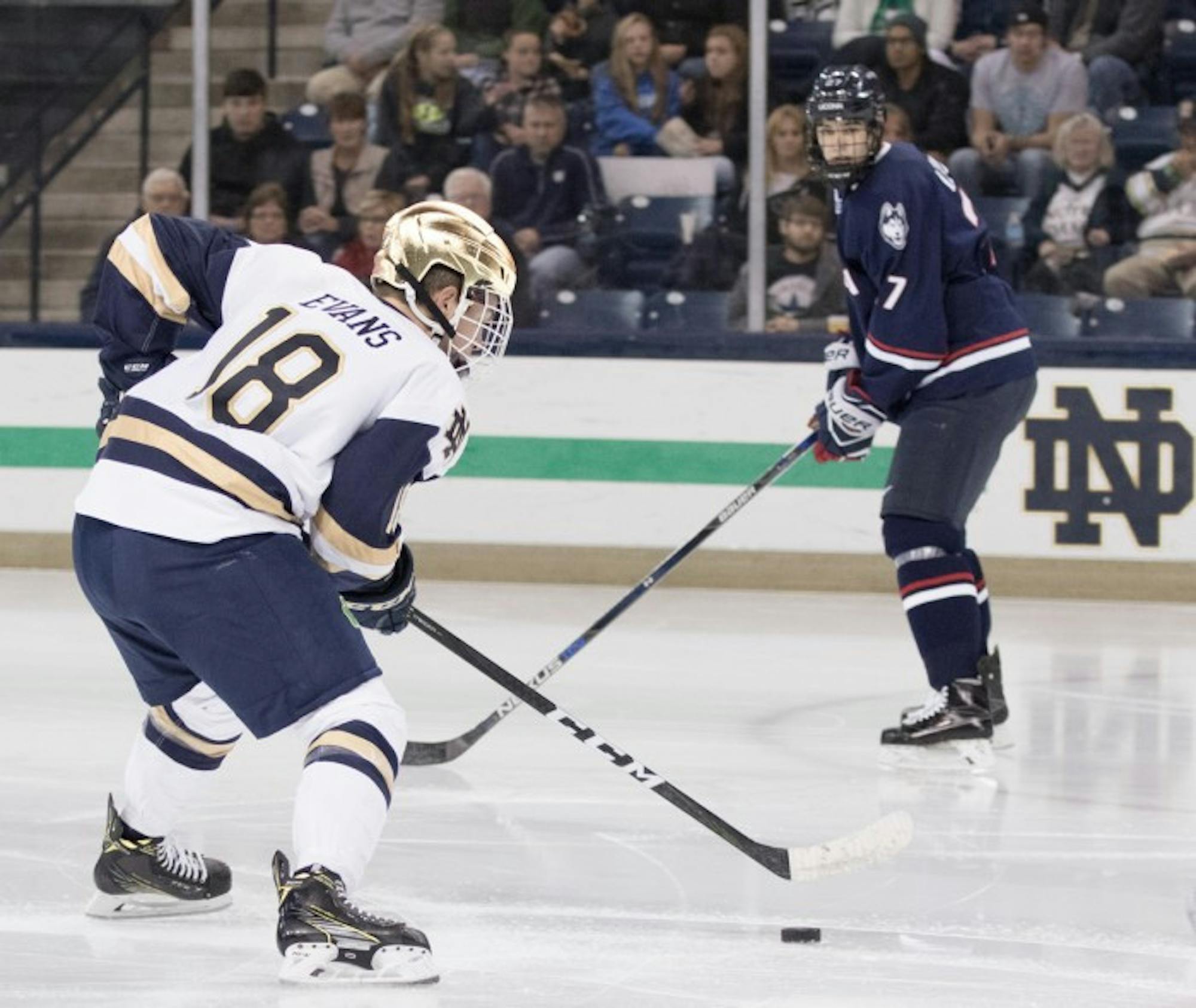 Irish junior forward Jake Evans looks to move the puck during Notre Dame’s 4-2 loss against UConn on Oct. 27 at Compton Family Ice Arena.