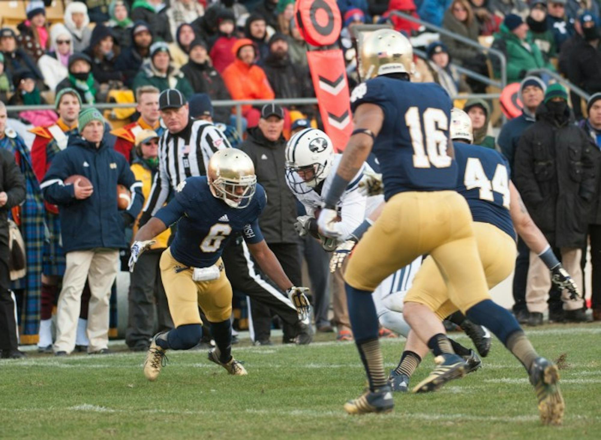 Senior cornerback KeiVarae Russell, left, prepares to make a tackle during Notre Dame’s 23-13 win over BYU at Notre Dame Stadium on Nov. 23, 2013. Russell was one of five players suspended in summer 2014 as part of the “Frozen Five” scandal. Notre Dame was placed on probation by the NCAA and ordered to vacate wins from the 2012 and 2013 seasons Tuesday.