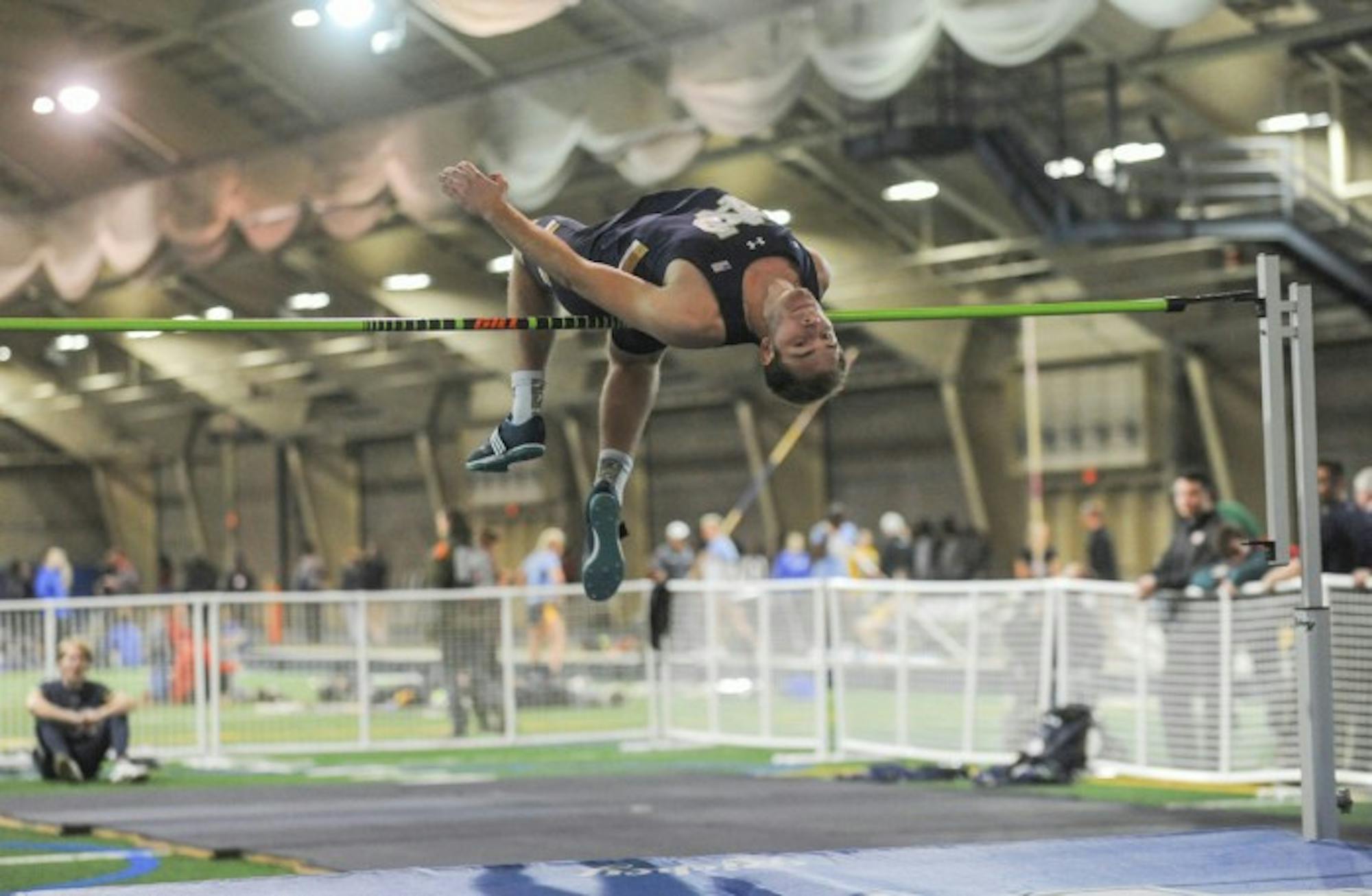 Irish junior Hunter Holton attempts to clear the bar during the Blue & Gold Invitational on Friday at Loftus Sports Complex.