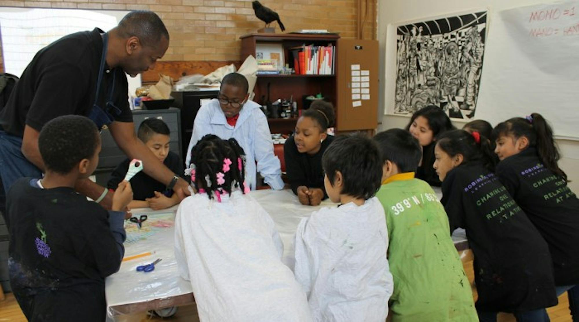 Artist Steve Prince leads children in the Notre Dame Center for Arts and Culture's (NDCAC) after school program in a mono type print workshop activity in March 2017. The NDCAC offers a variety of educational programs.