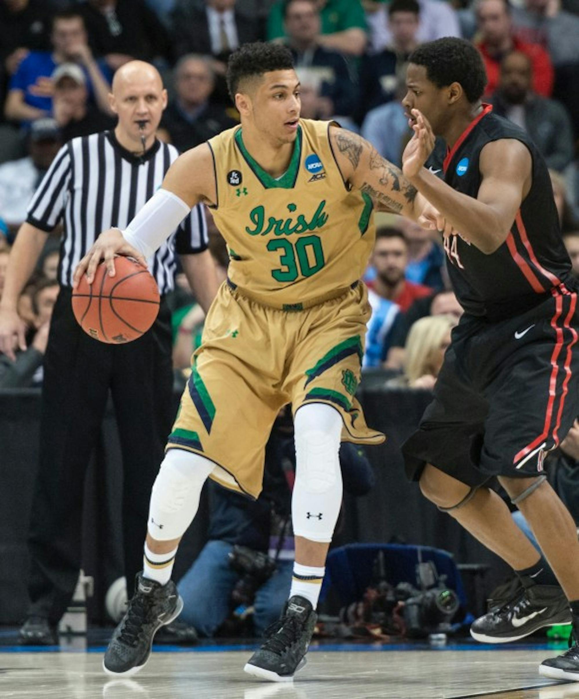 Irish senior forward Zach Auguste backs down his defender and surveys the court during Notre Dame’s  69-65 win over Northeastern on March 19 at CONSOL Energy Center.