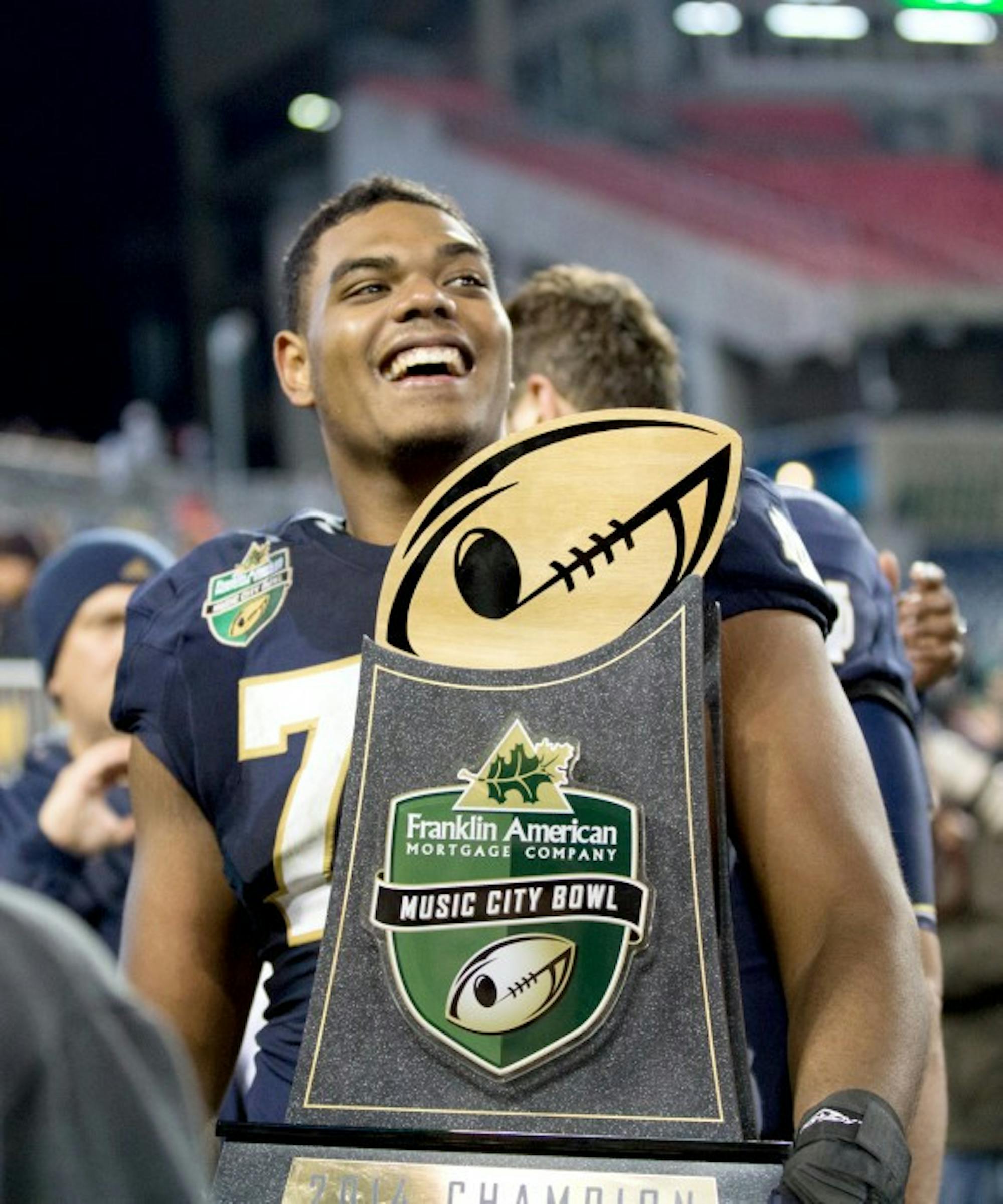 Irish junior offensive lineman Ronnie Stanley celebrates with the Music City Bowl trophy after Notre Dame’s 31-28 win over LSU.