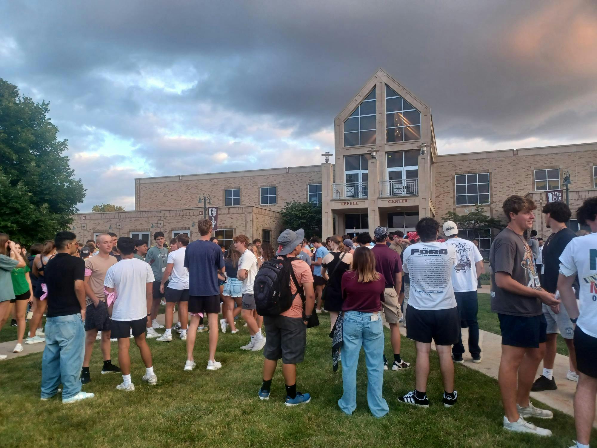 Students stand in front of the Pfeil Center for Saints Survivors tournament.jpg