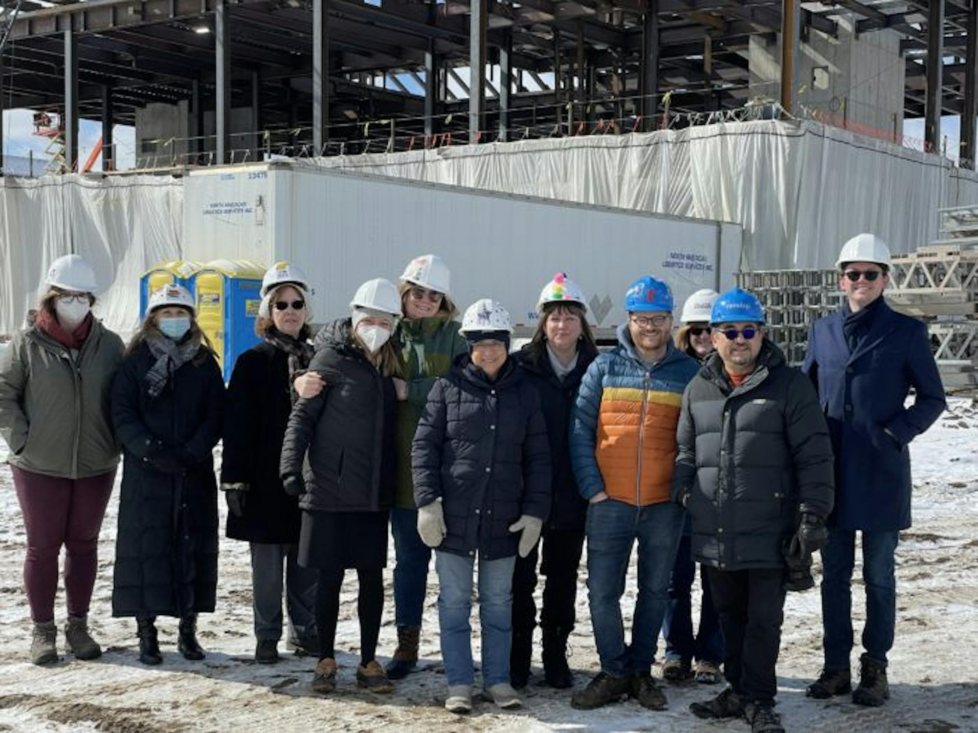 Snite museum employees dressed in winter clothes outside of the Raclin Murphy construction site