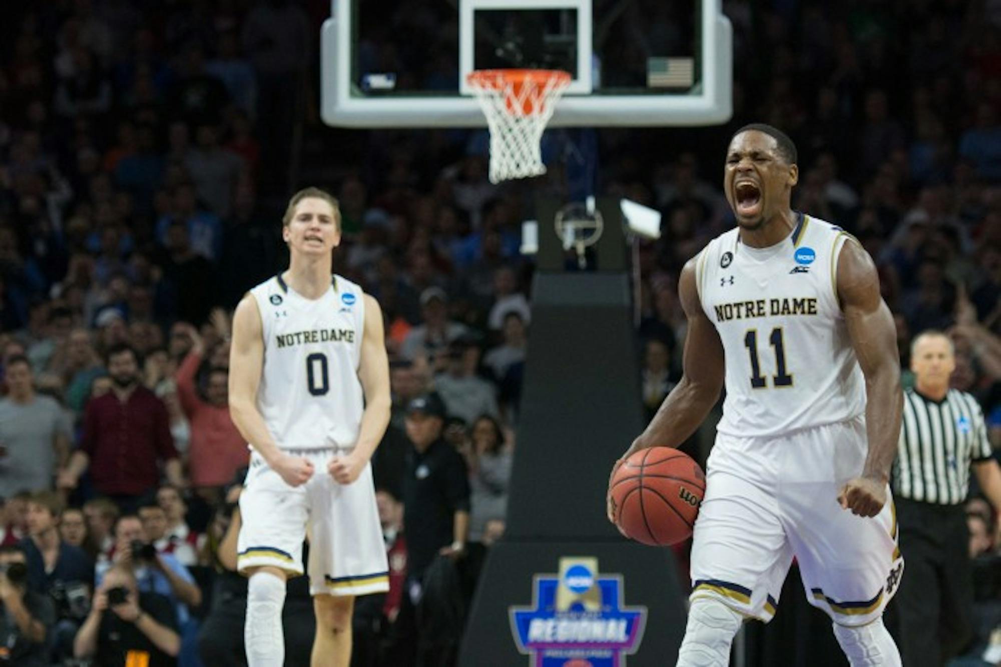 Junior forward Demetrius Jackson, right, celebrates near the conclusion of Notre Dame’s 61-56 NCAA tournament win over Wisconsin on Friday at Wells Fargo Center in Philadelphia.