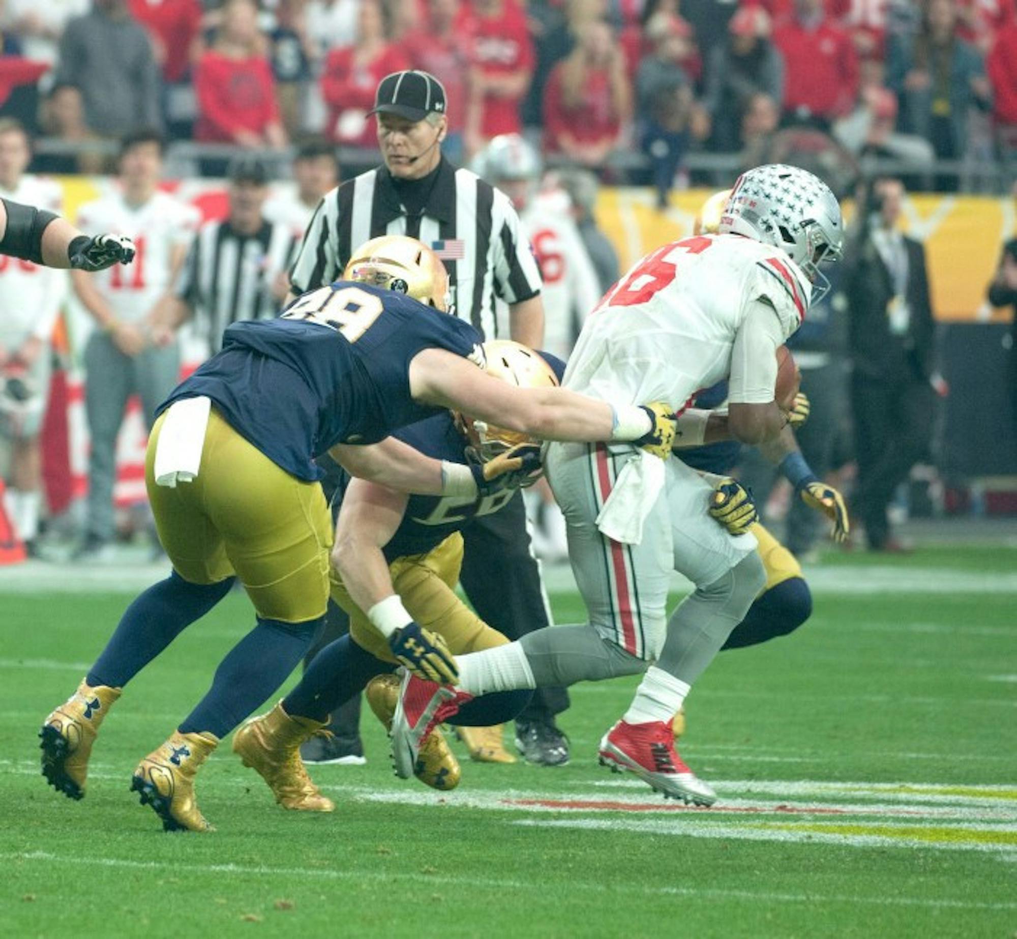 Irish sophomore defensive lineman Andrew Trumbetti tackles Ohio State sophomore quarterback J.T. Barrett during Notre Dame's 44-28 loss to the Buckeyes on Friday in the Fiesta Bowl in Glendale, Arizona.