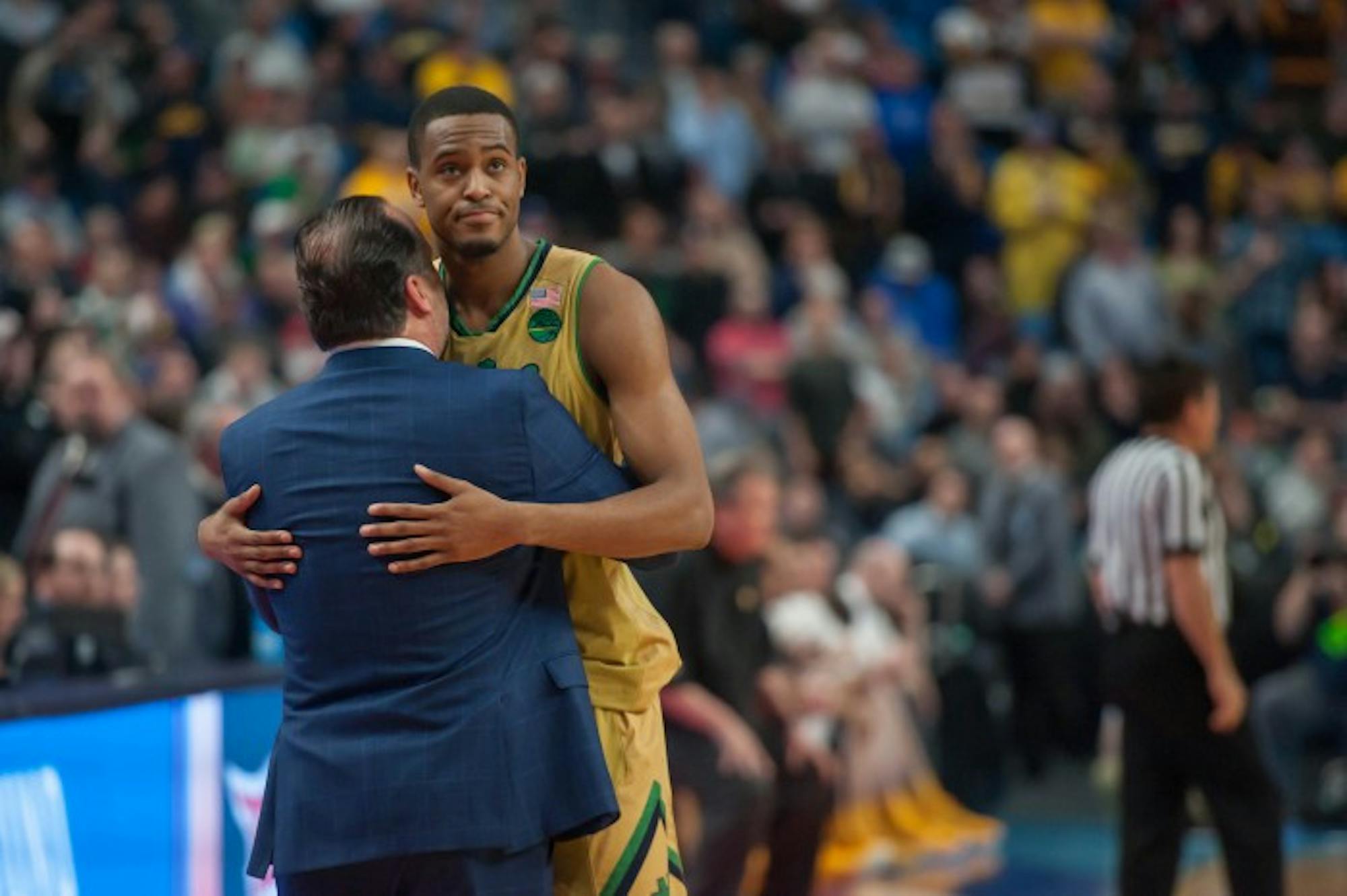 Irish senior forward V.J. Beachem hugs head coach Mike Brey in the final minutes of Notre Dame's 83-71 loss to West Virginia on Saturday at KeyBank Arena.