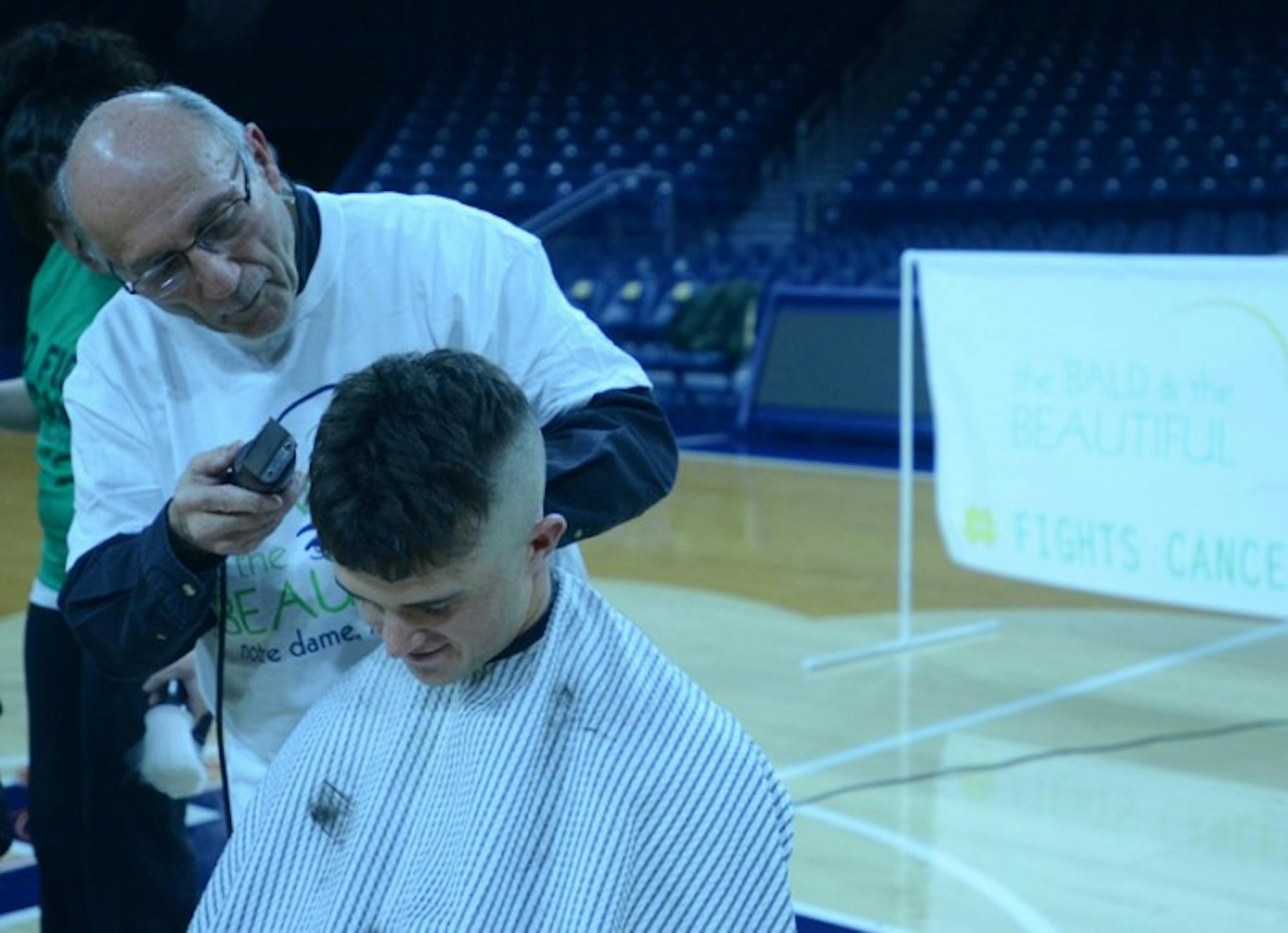 Sophomore pitcher Michael Hearne receives a haircut as part of a fundraiser for cancer research. The entire Irish program took part.