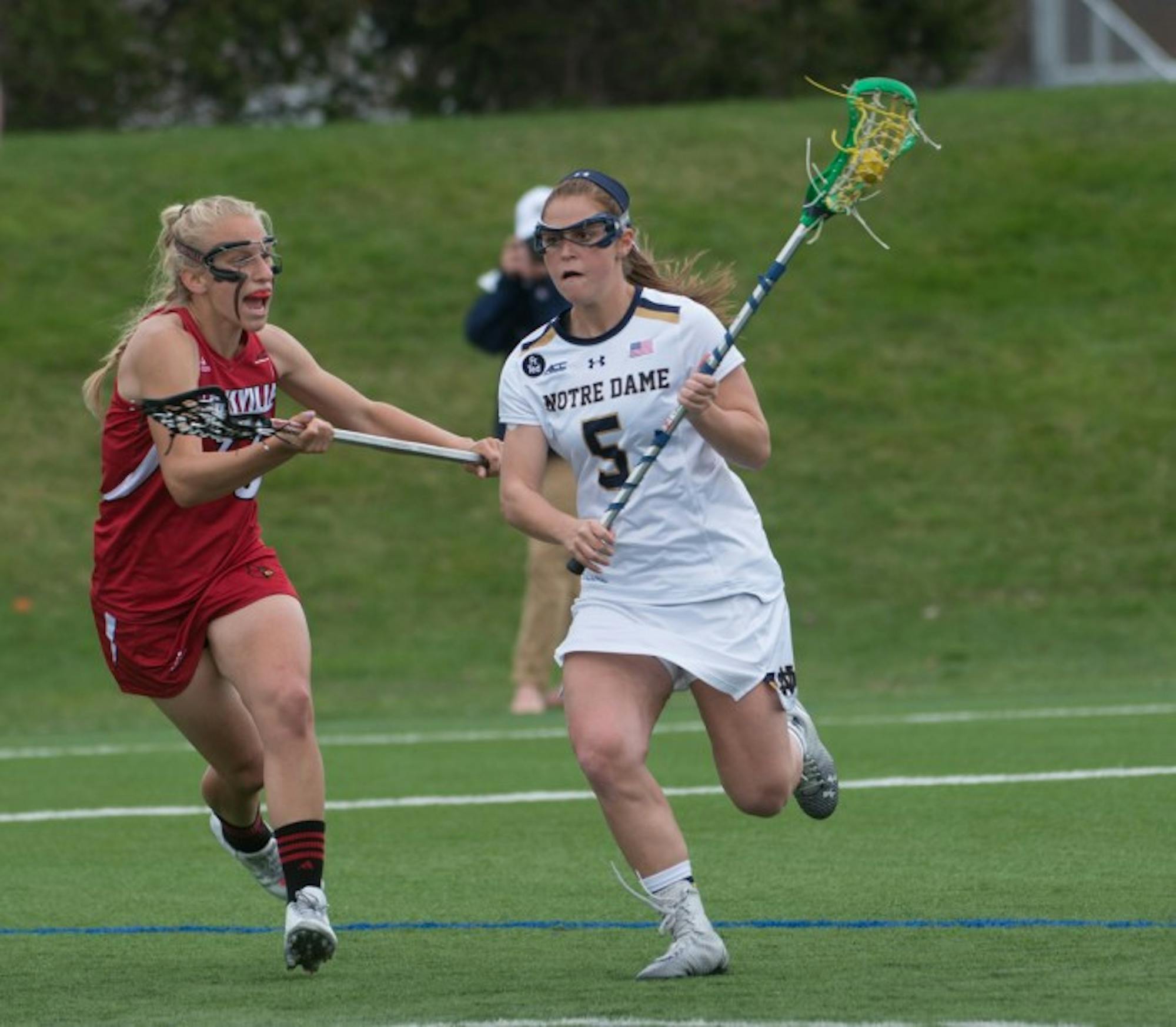 rish graduate student defender Barbara Sullivan possesses the ball during Notre Dame’s 10-8 home loss to Louisville on April 19.