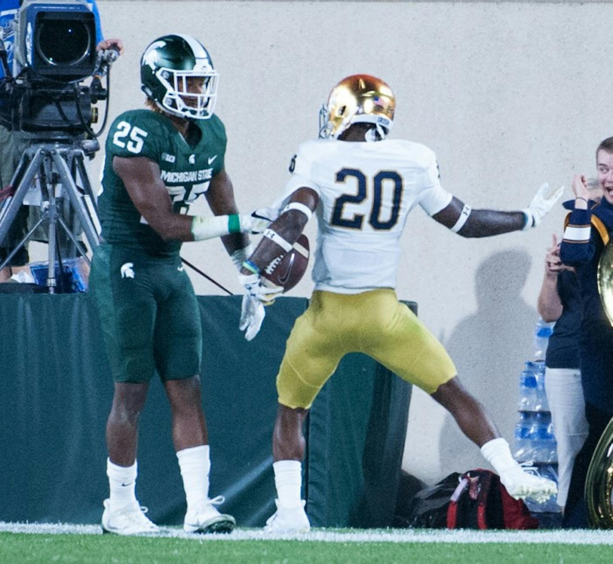 Irish junior cornerback Shaun Crawford celebrates after stripping the ball on the goal line and recovering the fumble in the endzone during Notre Dame’s 38-18 win over Michigan State on Saturday.