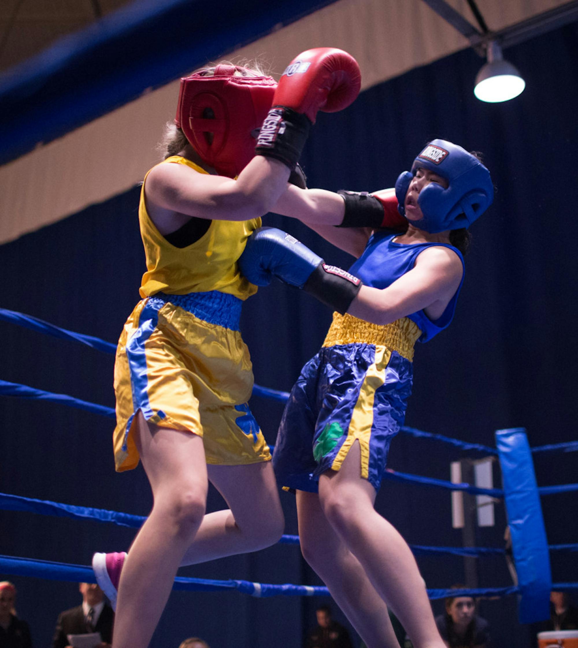 Senior Amanda “Boxing Panda” Leung connects on a jab to the body while absorbing a shot to the side of the head during her semifinal victory over sophomore Mia “The Hulk” Hogan-Davis on Tuesday night. Leung won her final against Casey “C My Fists” Gelchoin in a split decision Friday night at the Joyce Center Fieldhouse.