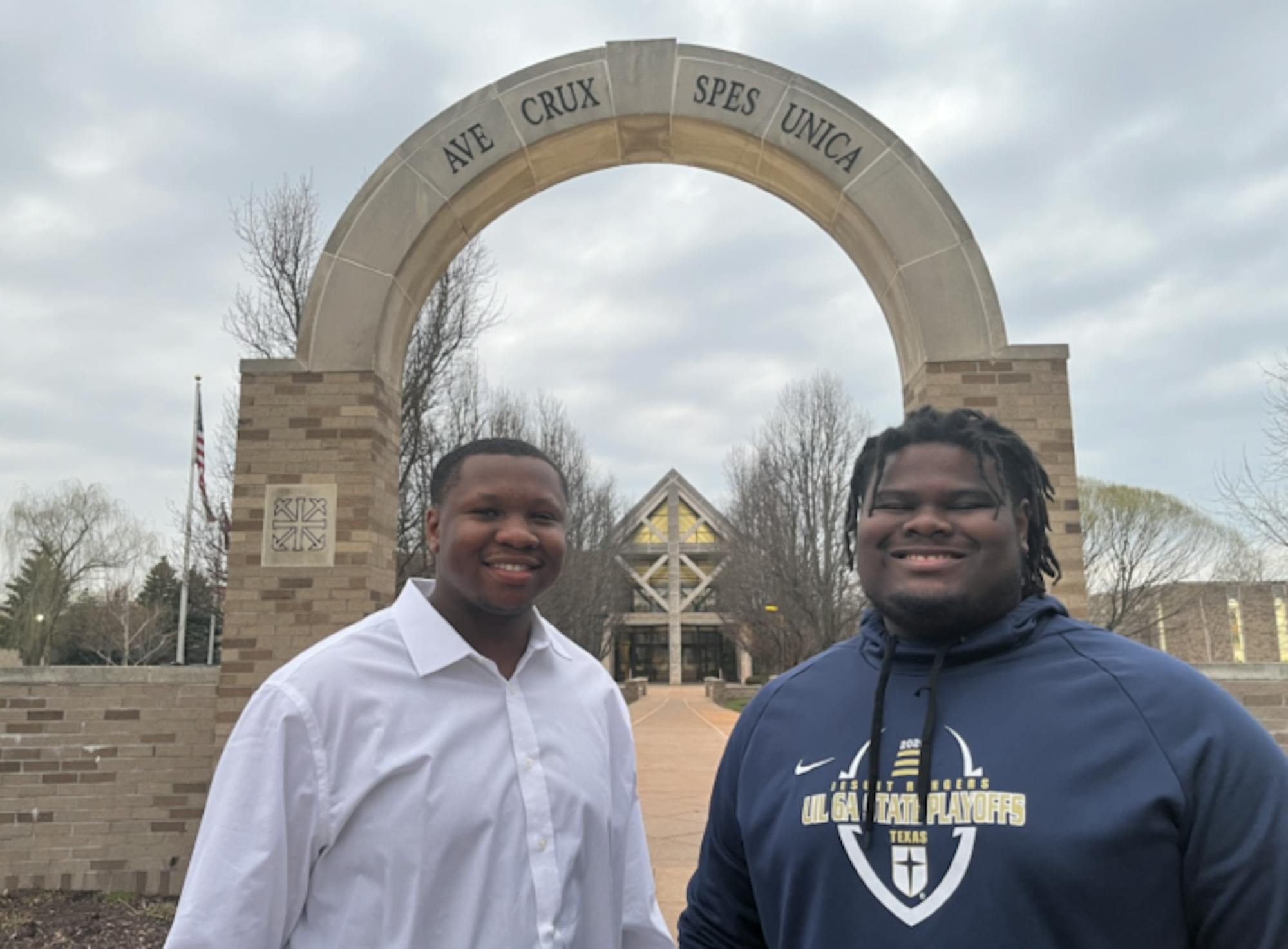 Dion Payne-Miller and Oscar Jarmon in front of the Holy Cross arch