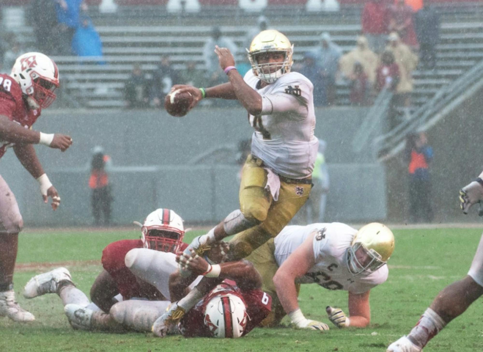 Irish junior quarterback DeShone Kizer throws the ball away under pressure during Notre Dame’s loss Saturday at Carter-Finley Stadium.