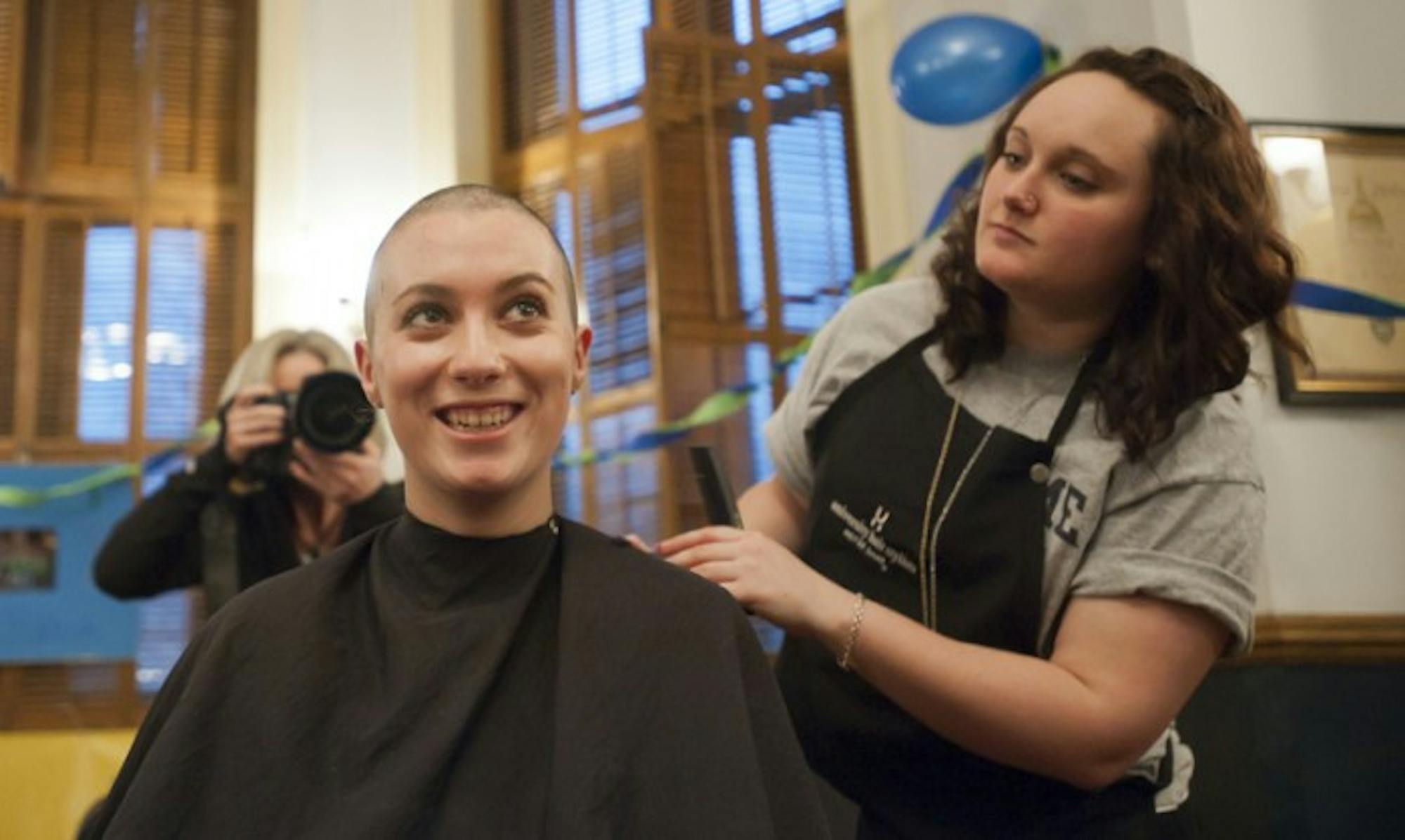 Former Notre Dame student Colleen Boyle gets her head shaved at last year’s The Bald and the Beautiful event. The club raises funds and spreads awareness for cancer research, with nearly 300 shaves per year.