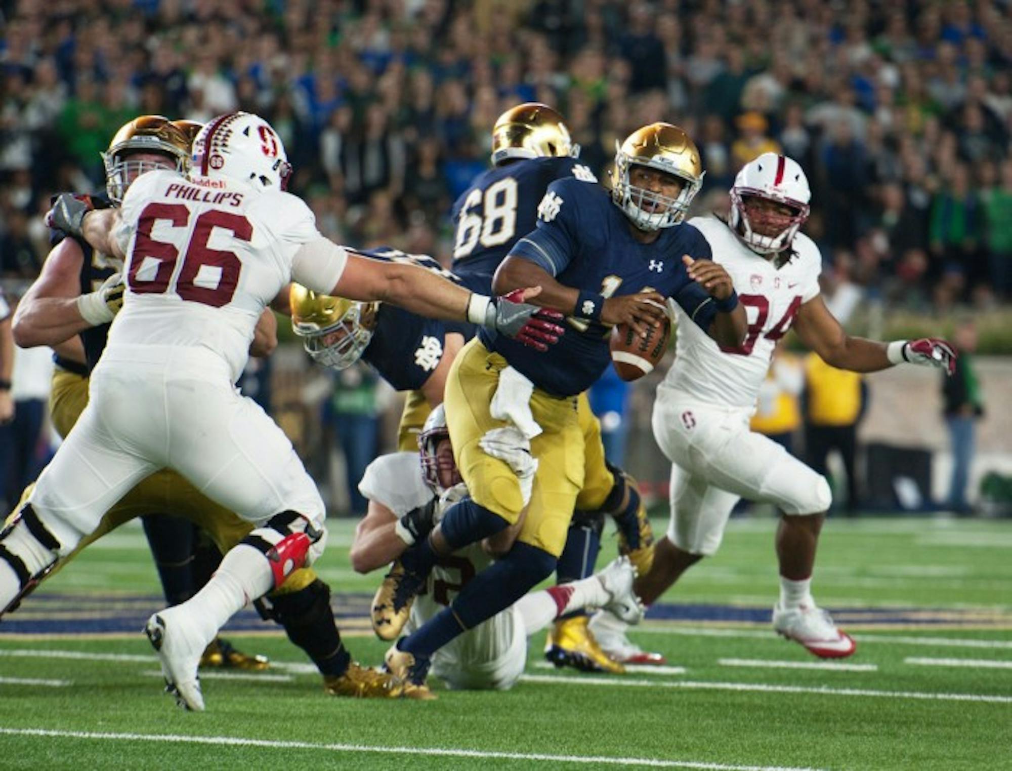 Irish junior quarterback DeShone Kizer scrambles away from a defender in Notre Dame's 17-10 loss to Stanford on Saturday.