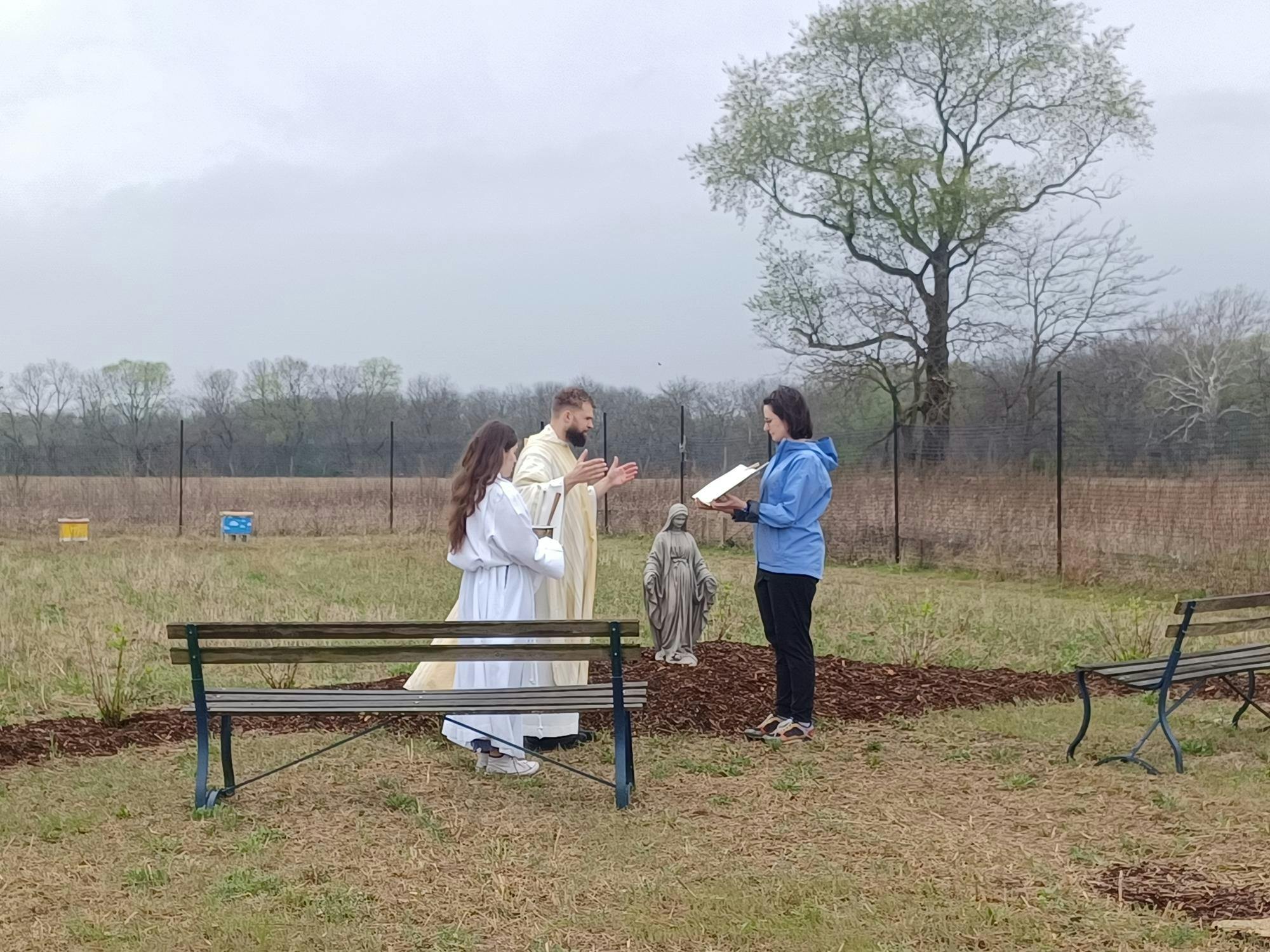 Students and staff surround the Mary Garden.jpg
