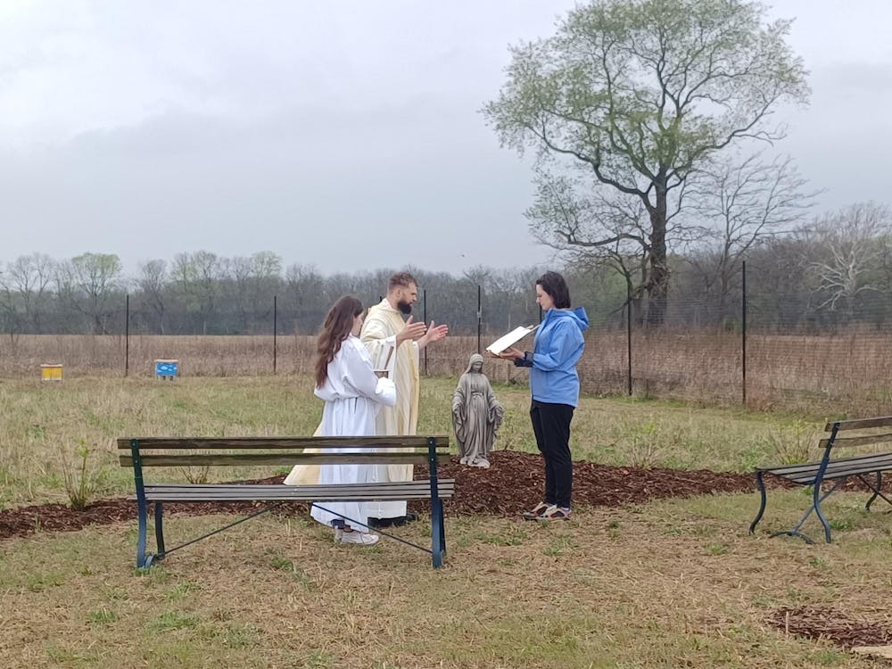 Students and staff surround the Mary Garden.jpg