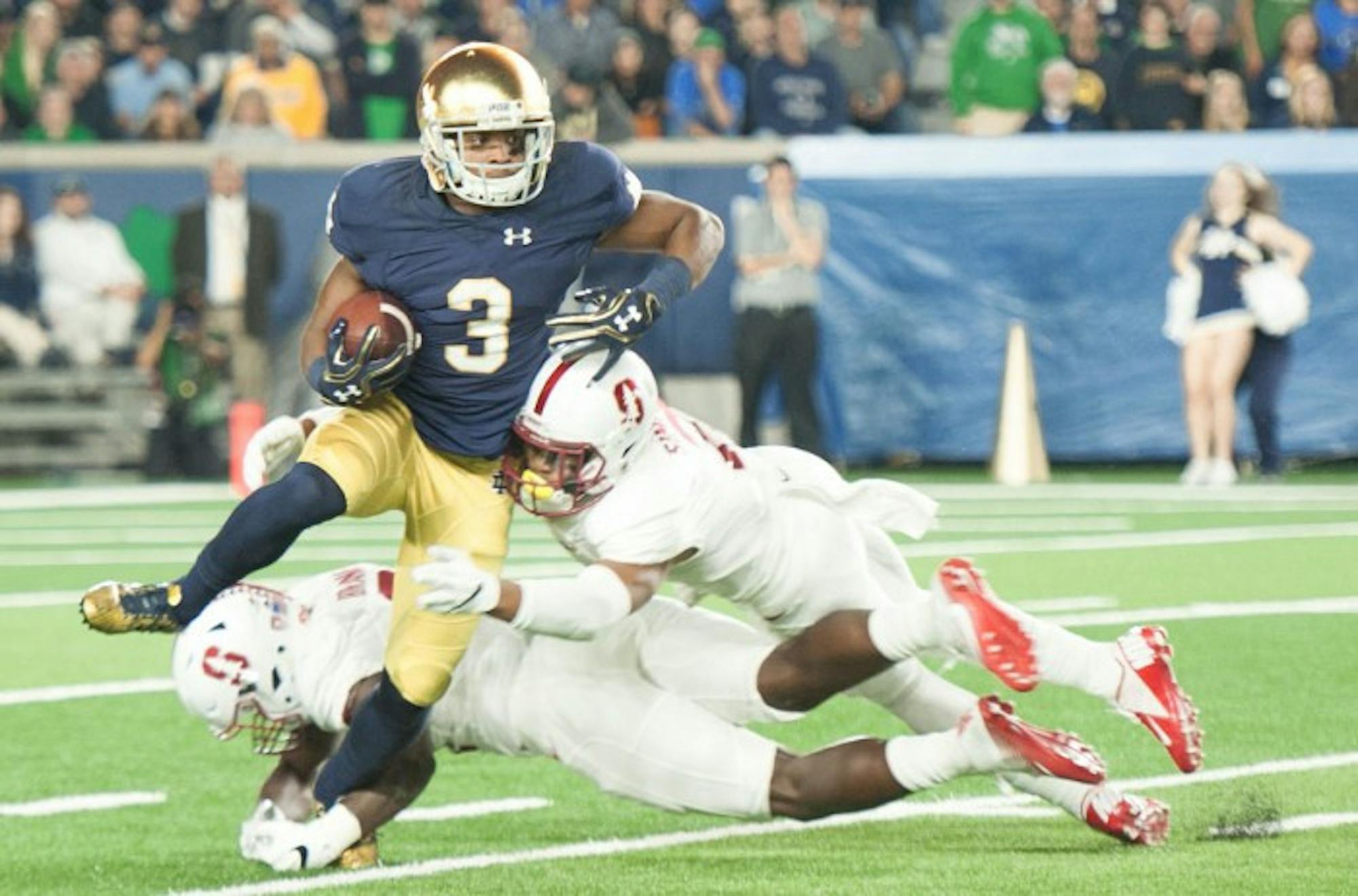 Irish sophomore wide receiver C.J. Sanders attempts to avoid getting tripped up by defenders in Notre Dame’s 17-10 loss to Stanford on Oct. 15. Sanders returned one punt and one kickoff in the game.