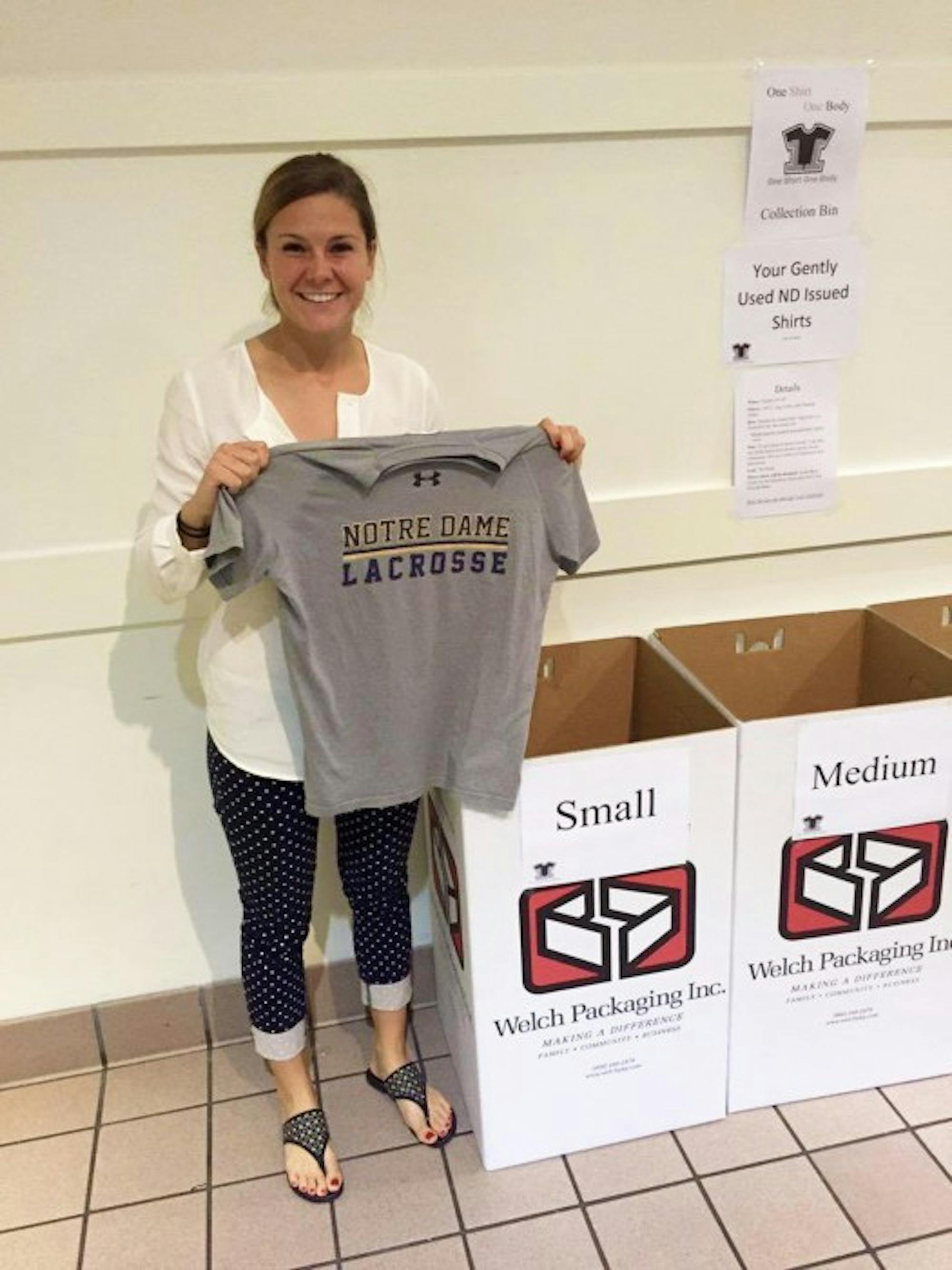 Senior Katherine McManus donates issued lacrosse gear in North Dining Hall for the One Shirt, One Body initiative.