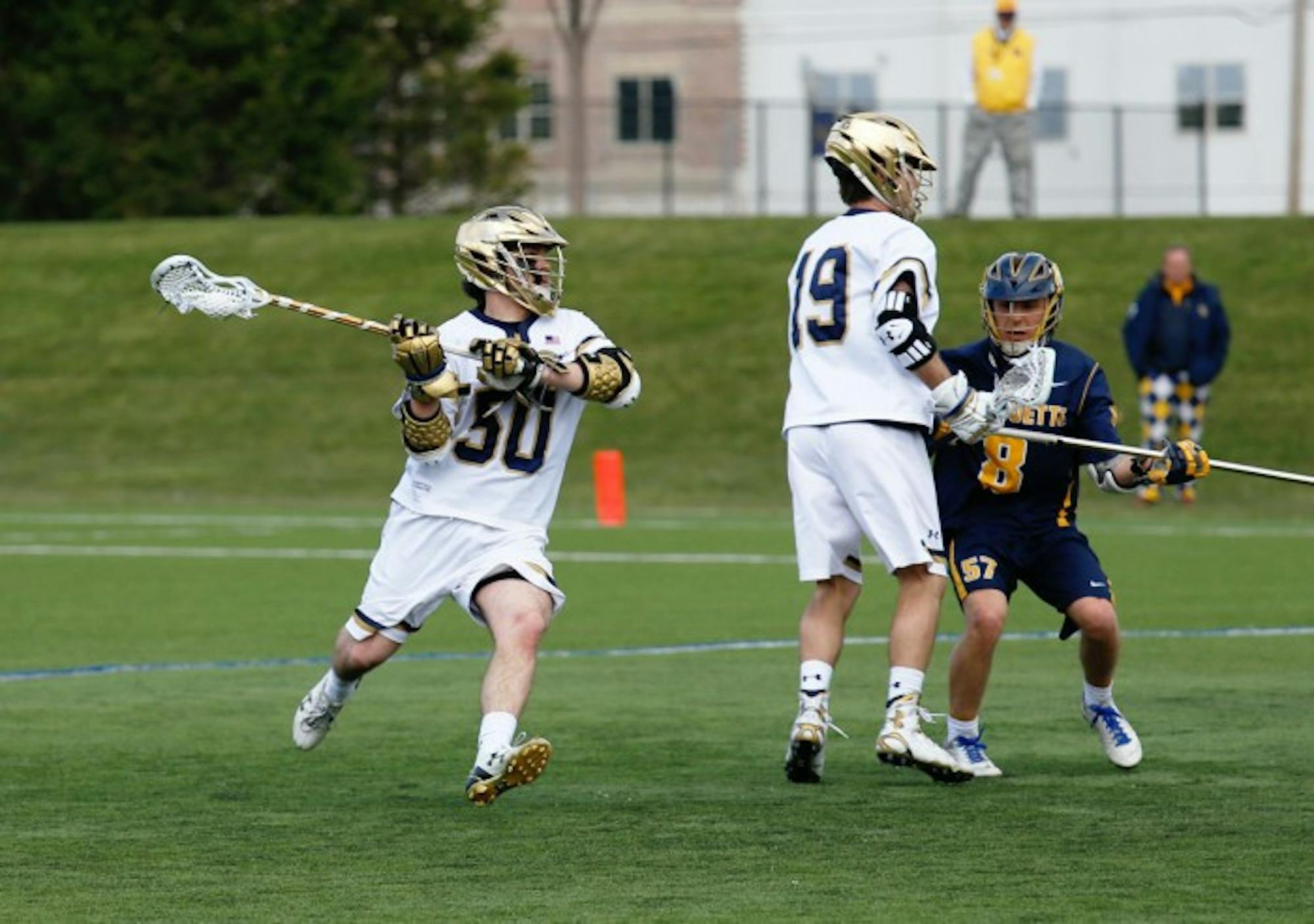 Irish senior attack Matt Kavanagh passes the ball during Notre Dame’s 8-7 overtime win over Marquette at Arlotta Stadium on Wednesday. Kavanagh scored five points and shot the winning goal of the game.