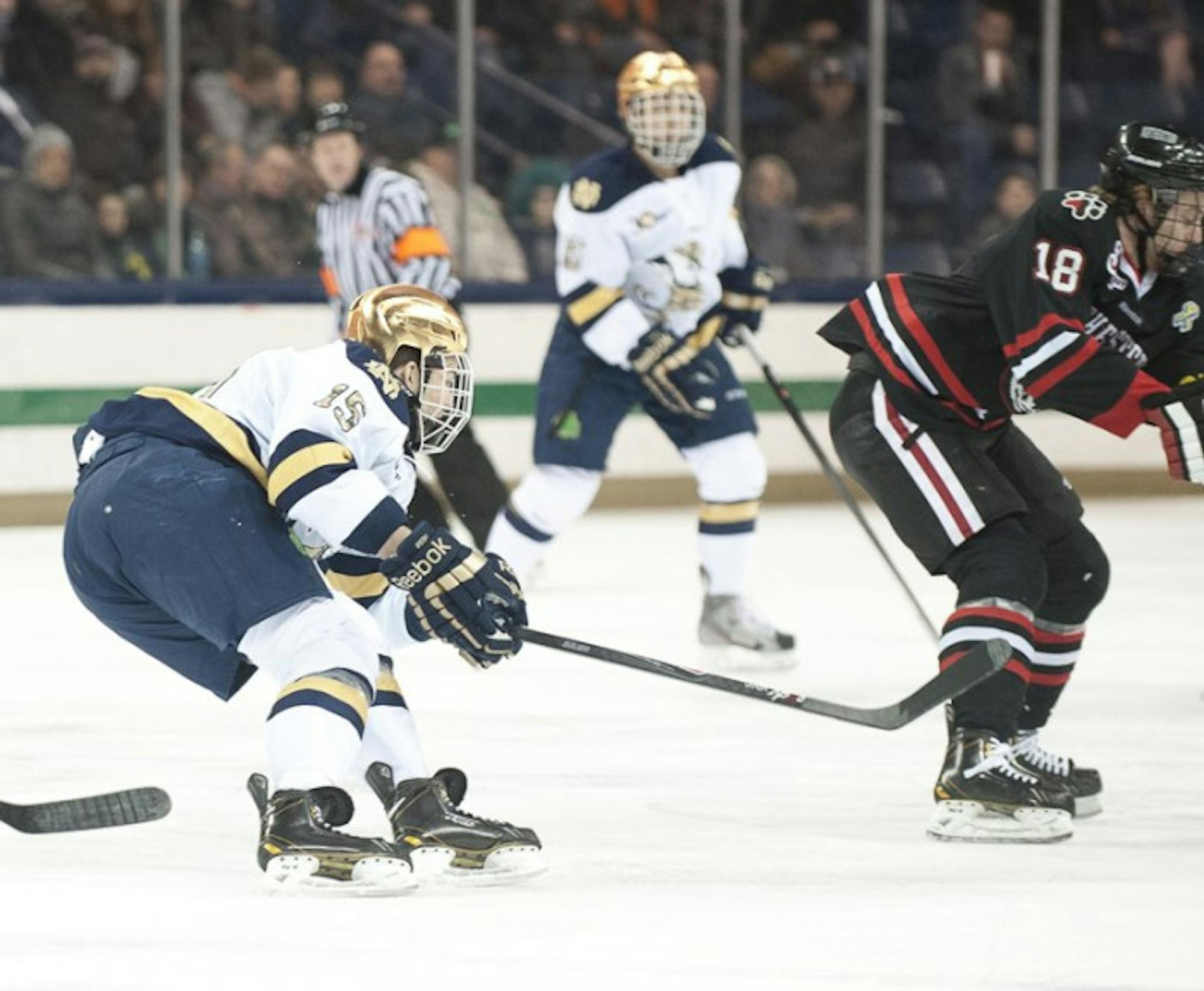 Irish junior right wing Peter Schneider pursues the puck during Notre Dame’s 4-0 loss to Northeastern on Friday.