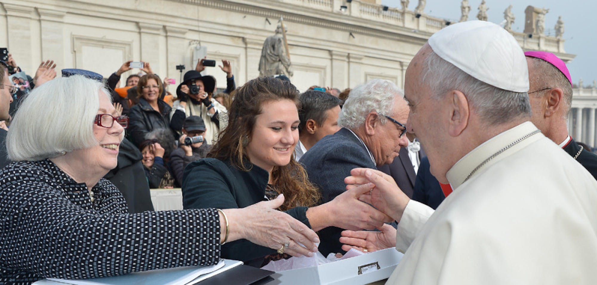 Saint Mary’s College President, Carol Ann Mooney (left), and senior Kristen Millar shake hands with Pope Francis as they deliver the 225 letters from Catholic women across the United States on Nov. 26.