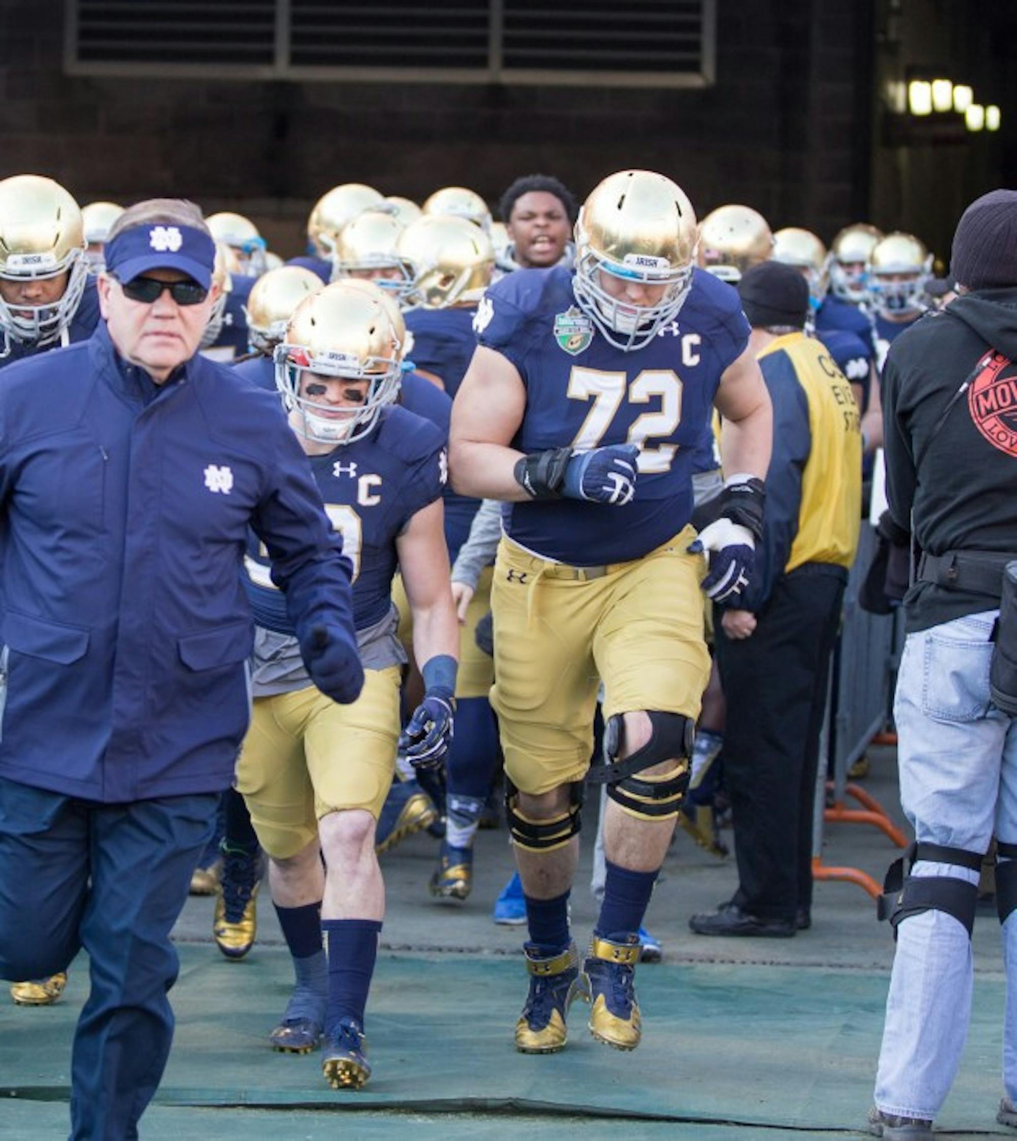 Graduate student center Nick Martin, 72, leads Notre Dame out of the tunnel before its 31-28 win in the Music City Bowl on Dec. 30.