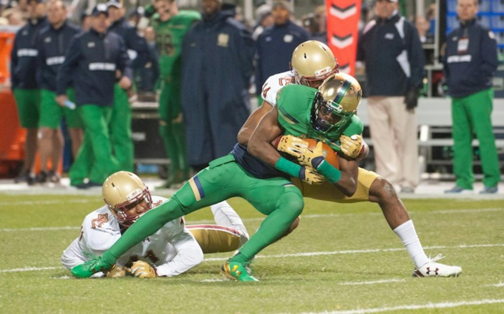 Irish junior receiver Torii Hunter Jr. fights for yardage during Notre Dame’s 19-16 victory over Boston College on Saturday at Fenway Park in Boston. Hunter landed on top of a defender’s body earlier in the play and spun off to gain more yardage, but after a review it was determined his elbow had hit the ground before he regained his balance.