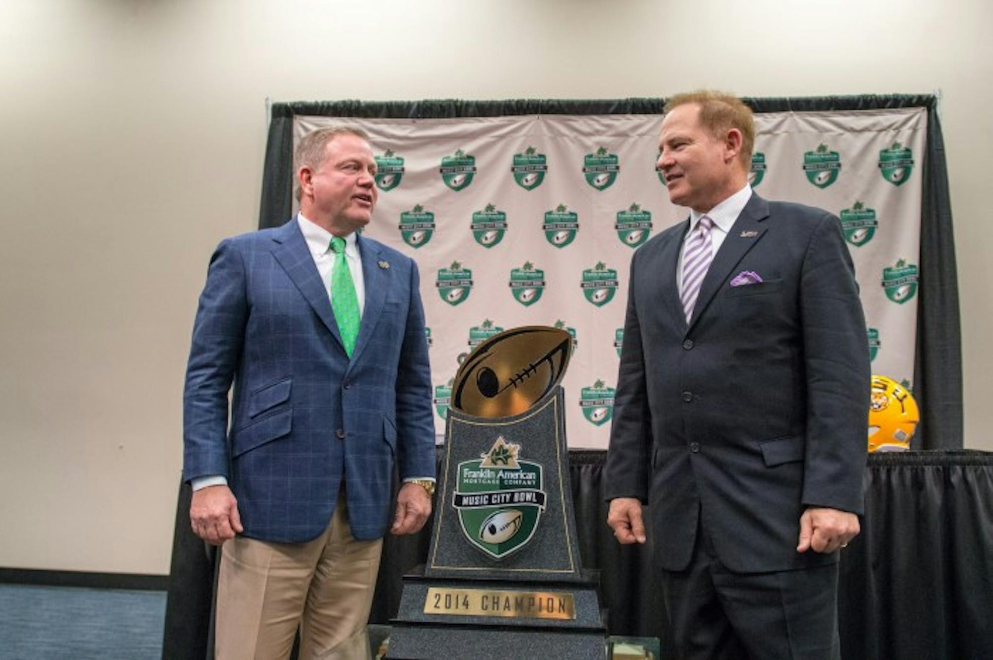 Notre Dame head coach Brian Kelly and LSU head coach Les Miles talk before a joint press conference Monday afternoon at LP Field in Nashville, Tennessee. Notre Dame and LSU will meet in The Franklin American Mortgage Music City Bowl on Tuesday afternoon.