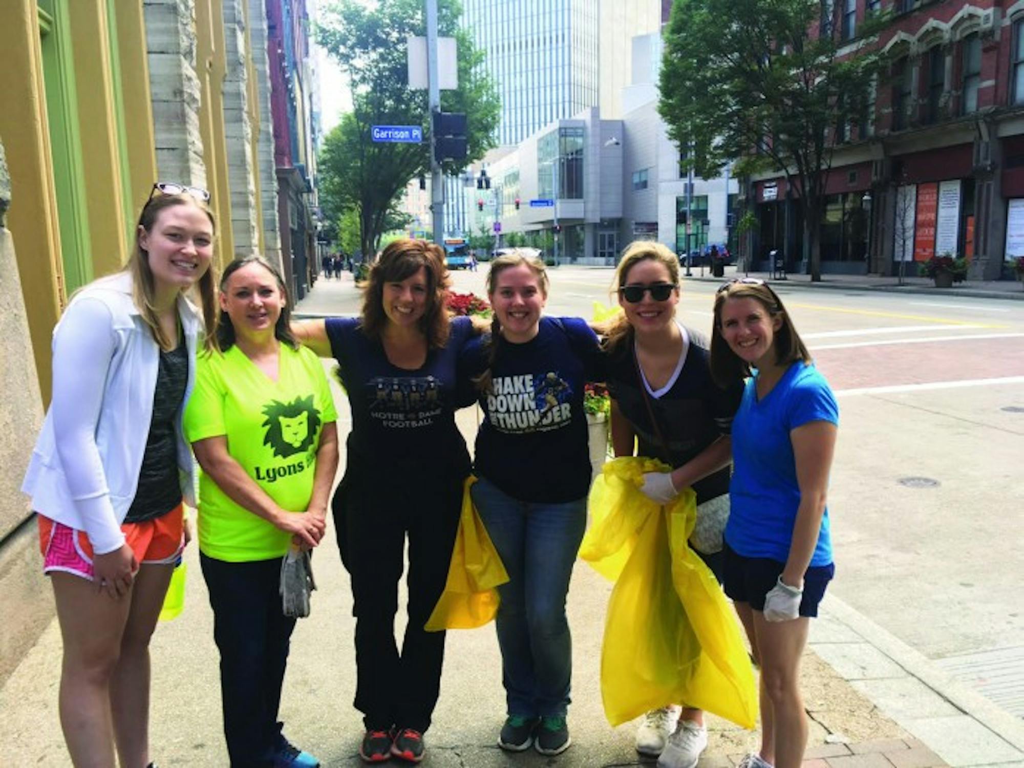 Members of the Notre Dame Club of Pittsburgh gather to complete community service before a Notre Dame football game.