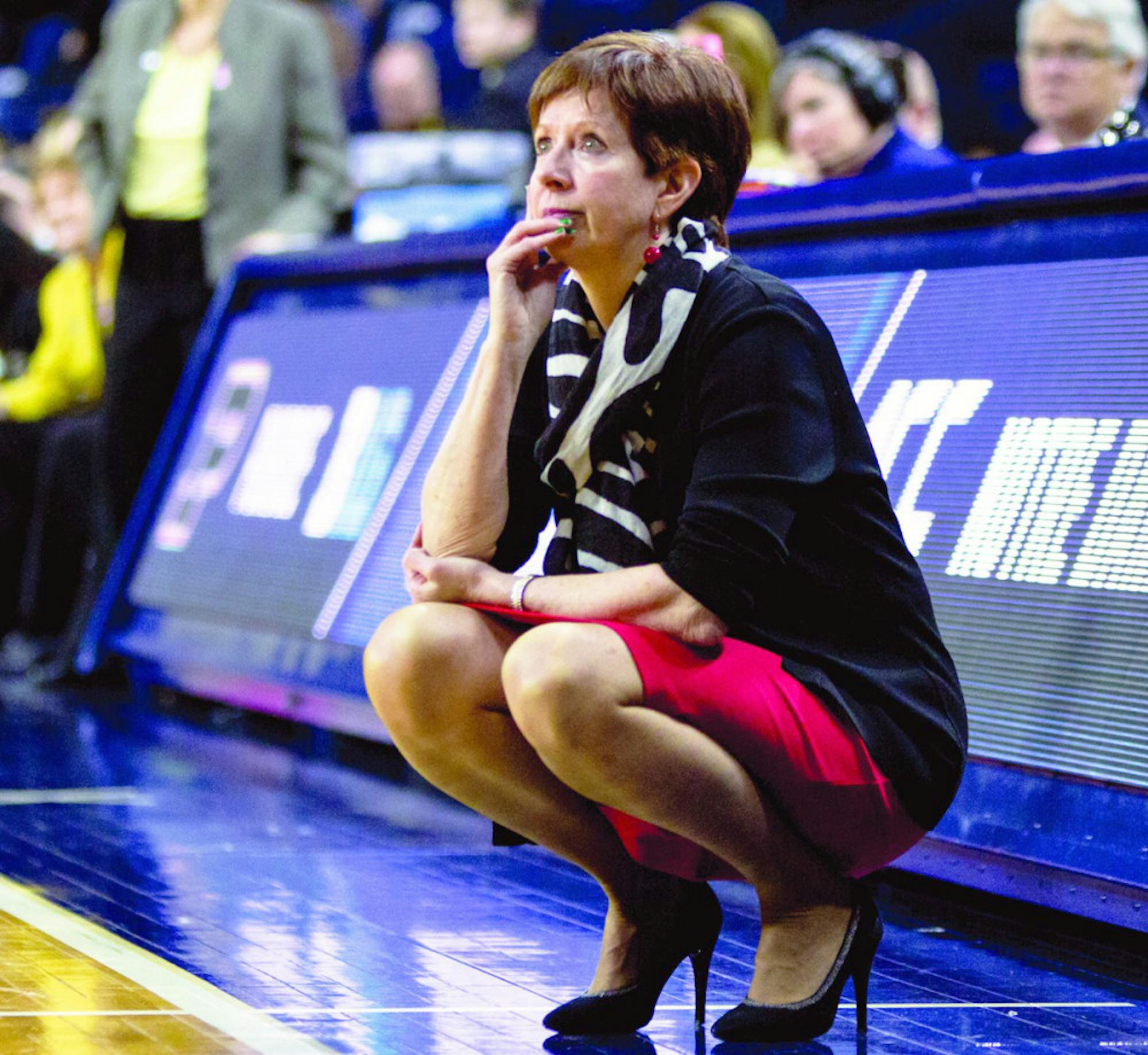 Irish head coach and Naismith Basketball Hall of Fame inductee Muffet McGraw crouches beside the court during Notre Dame’s 88-82 overtime win over Purdue on March 19 at Purcell Pavilion.