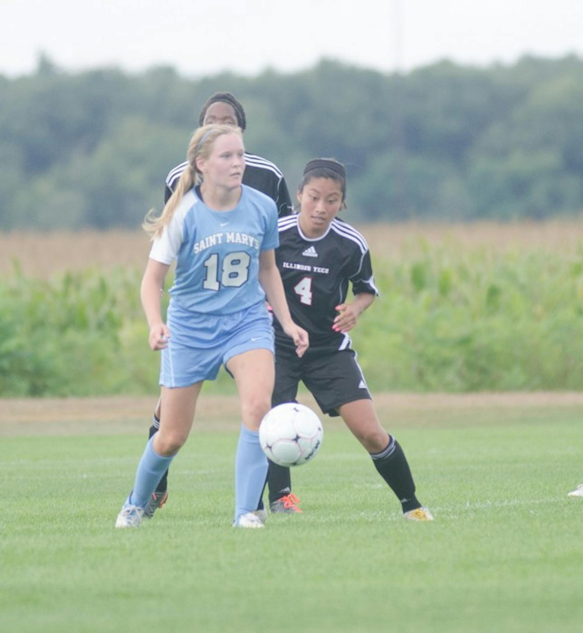 Saint Mary’s midfielder Maggie McLaughlin wards off defenders during the Belles’  4-1 victory over Illinois Tech on Sept. 2. McLaughlin started 19 games for the Belles in 2013.