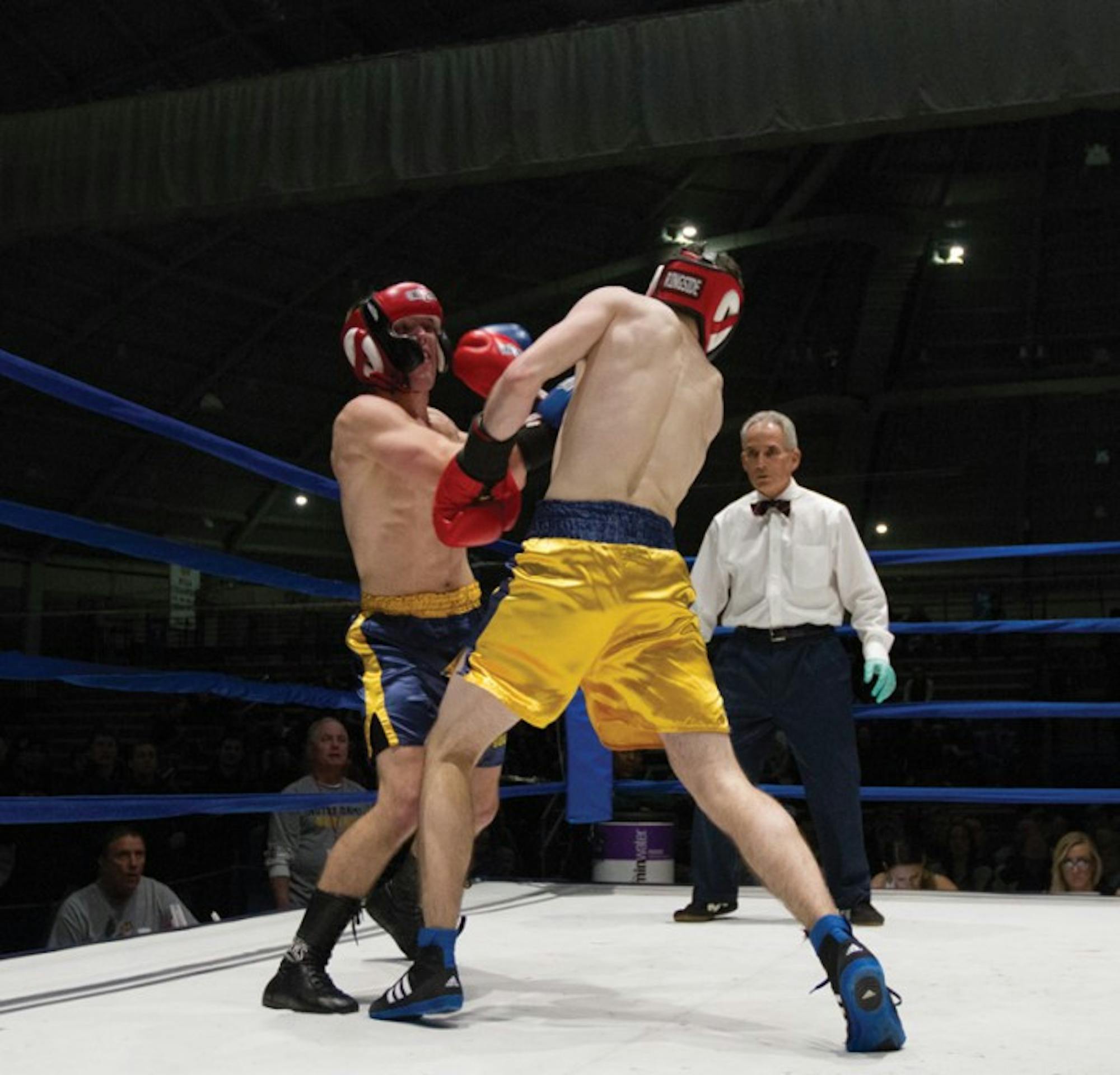 Senior captain Niels Seim, left, punches his way past the defense of freshman Patrick Brennan, in the semifinal round.