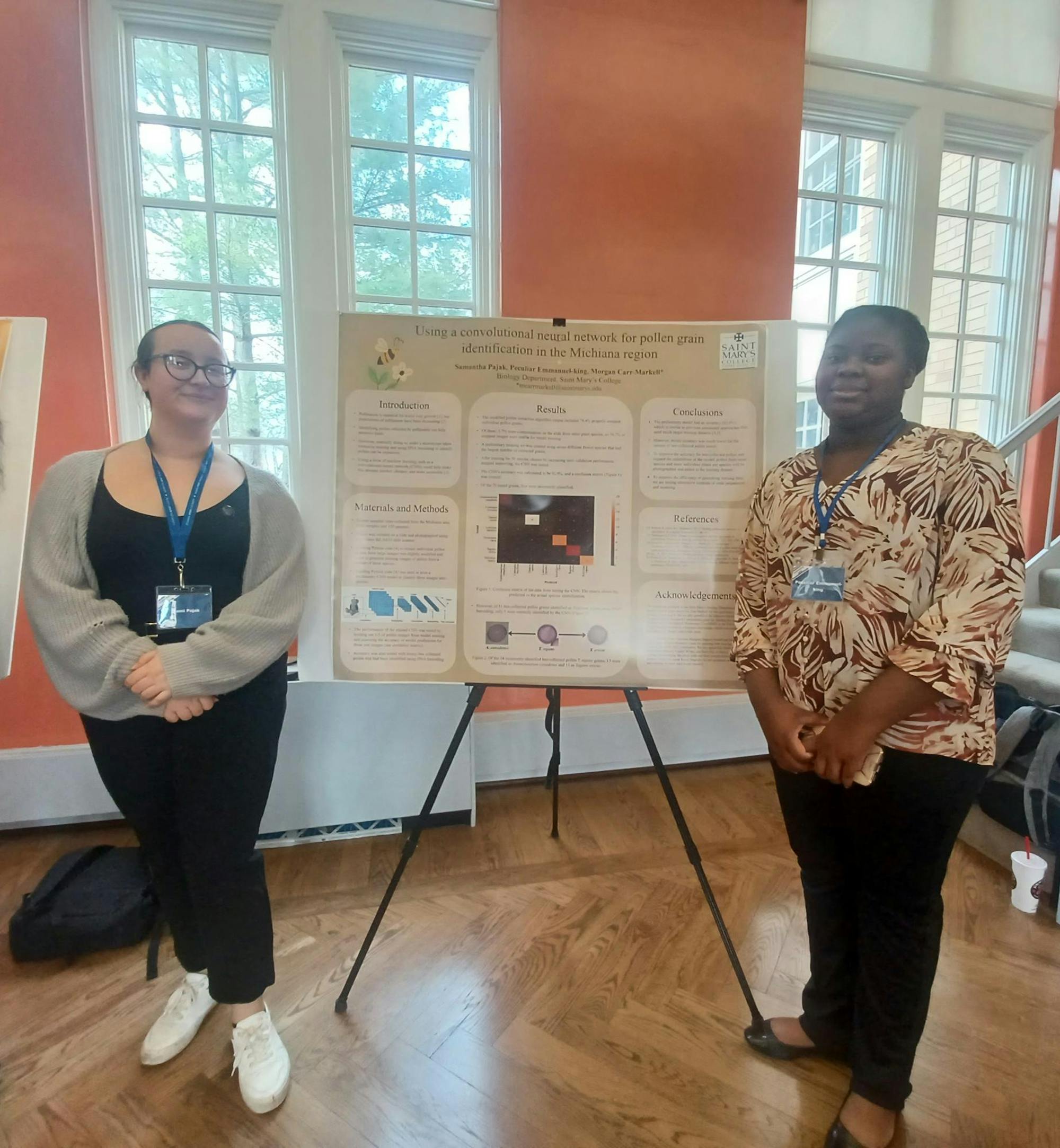 Senior Sami Pajak and sophomore Peculiar Emmanuel-King stand next to biology research project.jpg